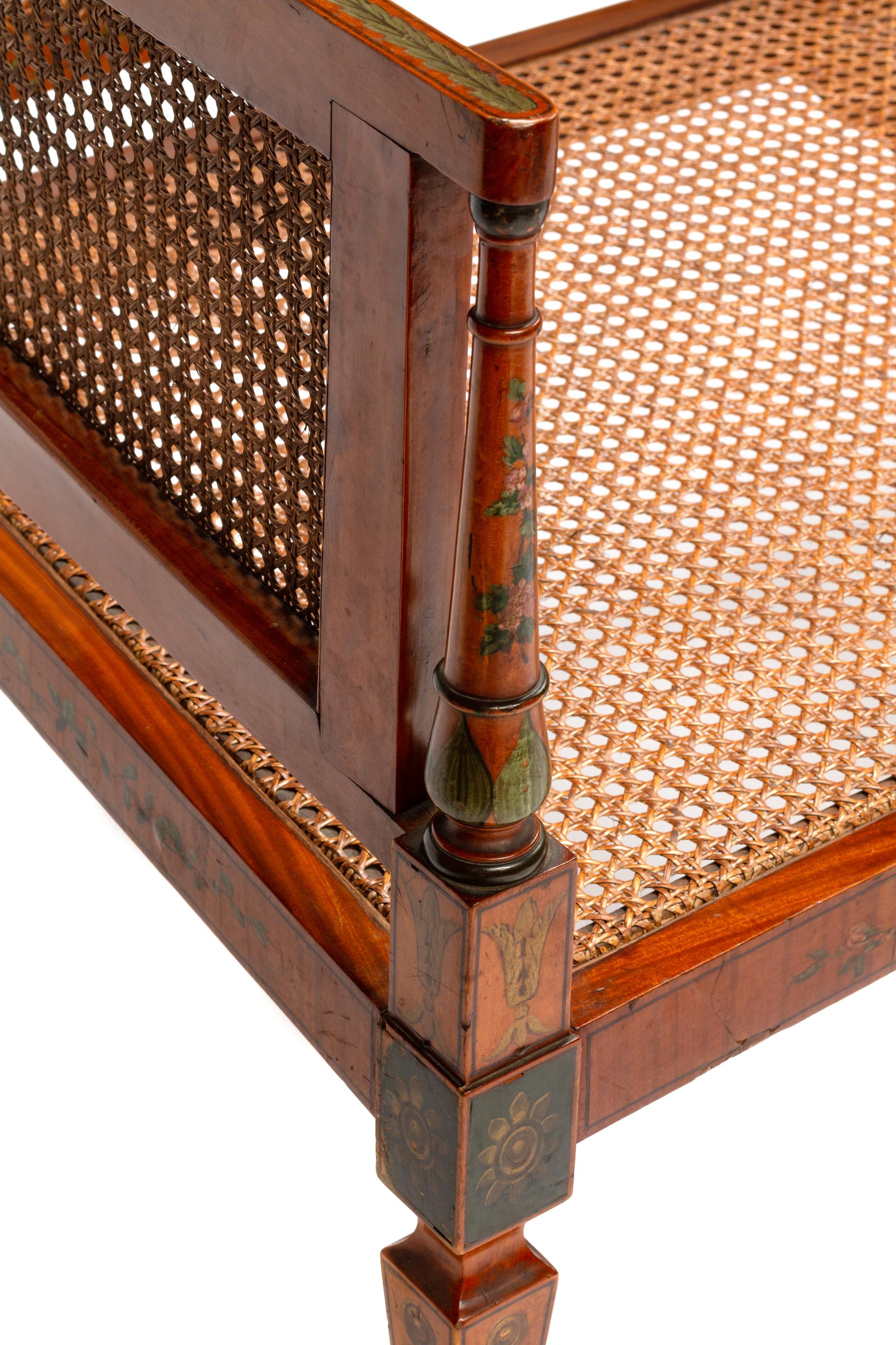 An Edwardian Painted Satinwood Caned Settee