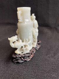 A Chinese jade "Boys, Kylin and Phoenix" vase on carved wood stand 玉雕童子凤鸟花樽及底座