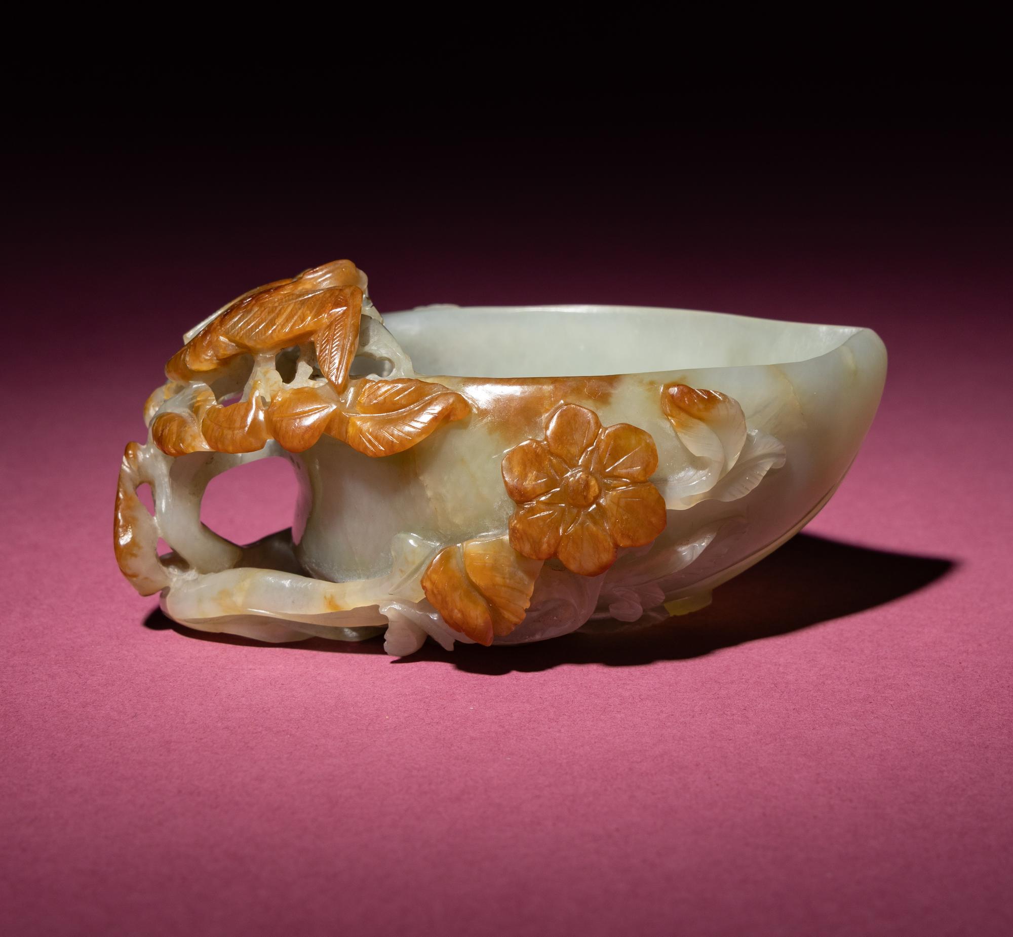 A Chinese Russet and Celadon Jade ‘Magpie and Plum Blossoms’ Peach-Form Coupe, 19th Century — 清晚期 青白玉帶皮喜上眉梢桃形杯