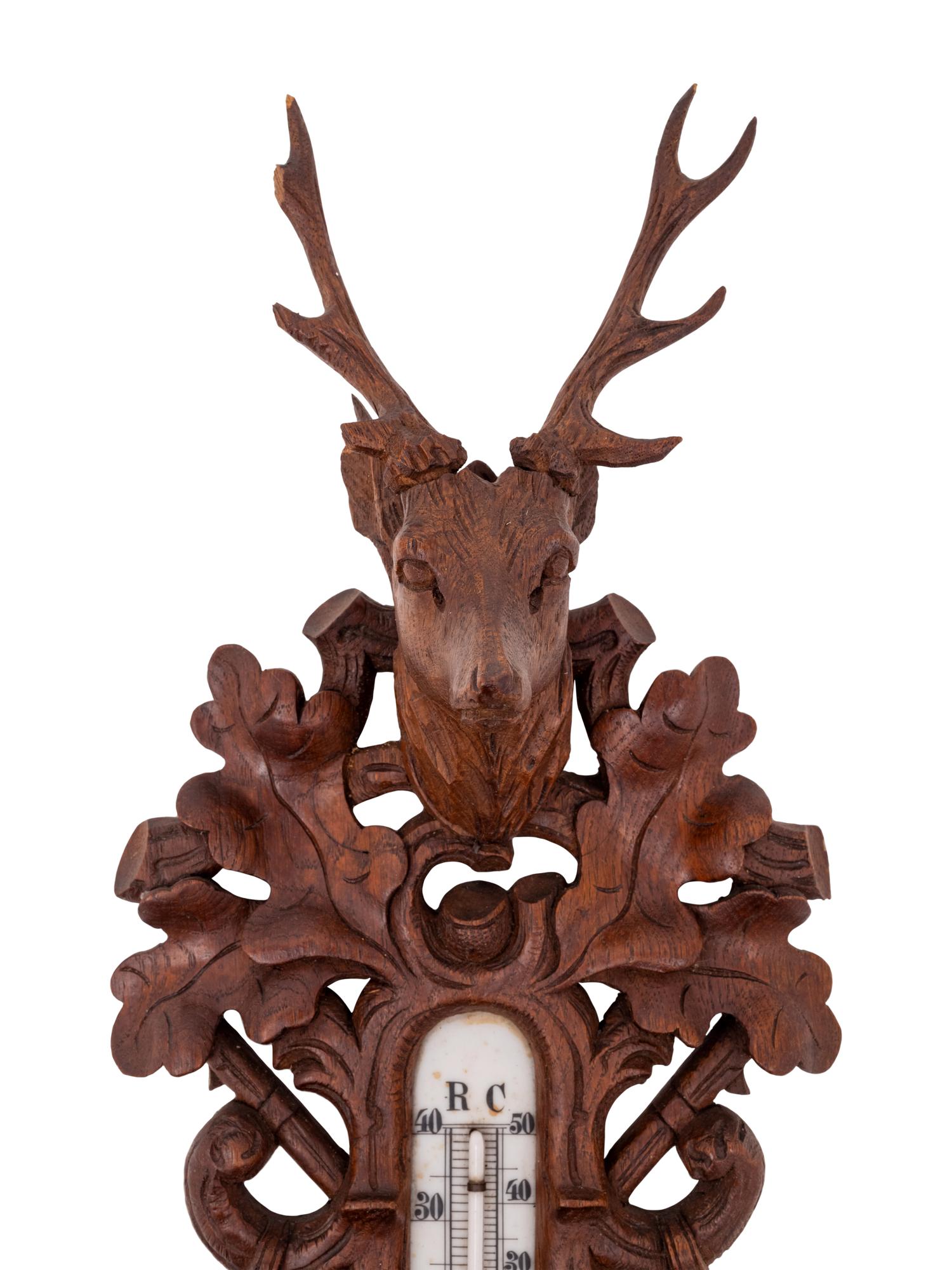 A Black Forest Carved Barometer and Thermometer