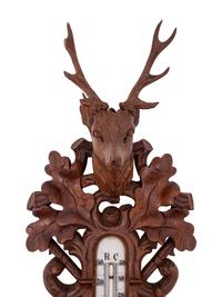 A Black Forest Carved Barometer and Thermometer