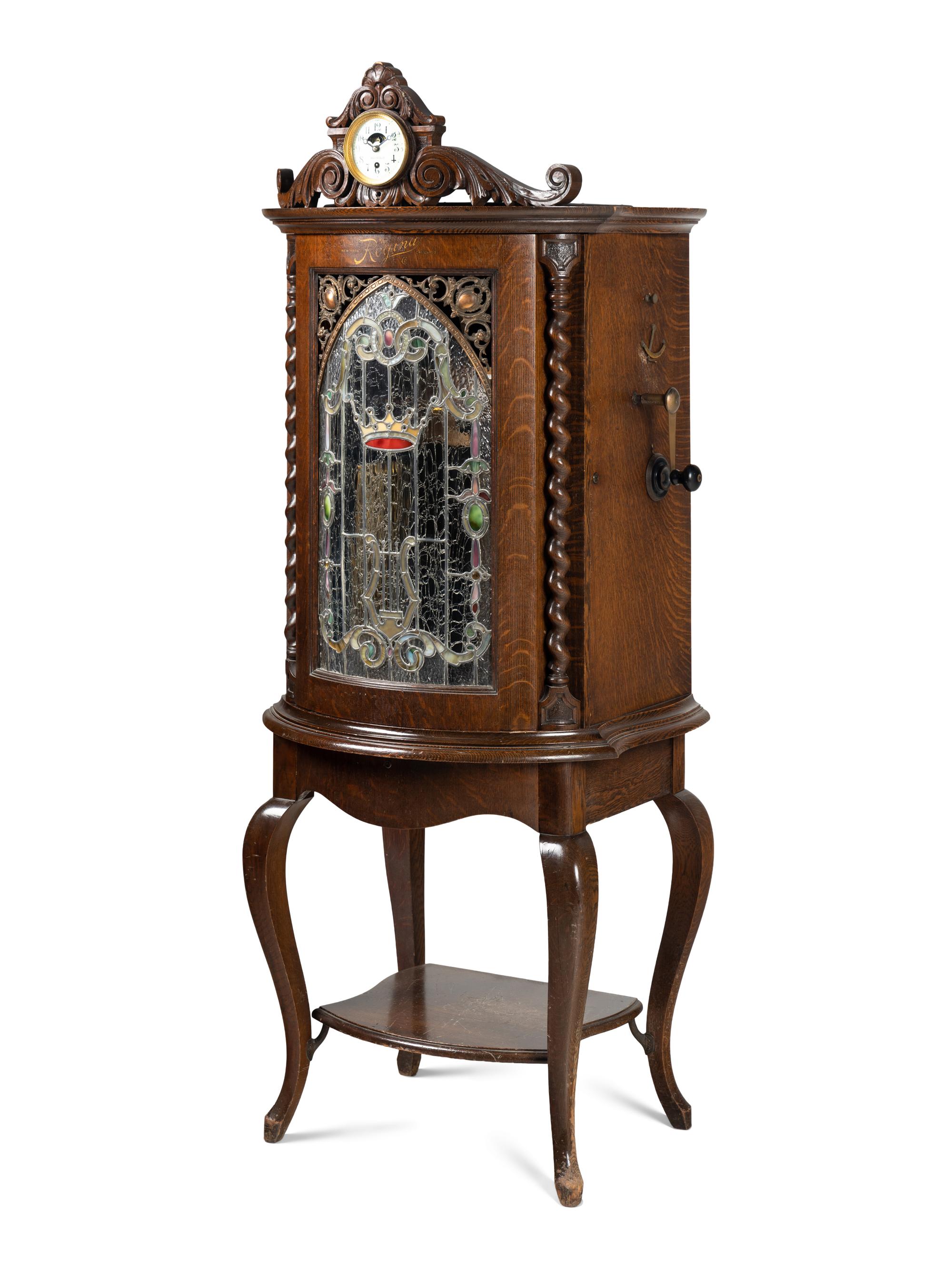 A Regina Corona 15 1/2 Inch Disk Change Music Box with Clock