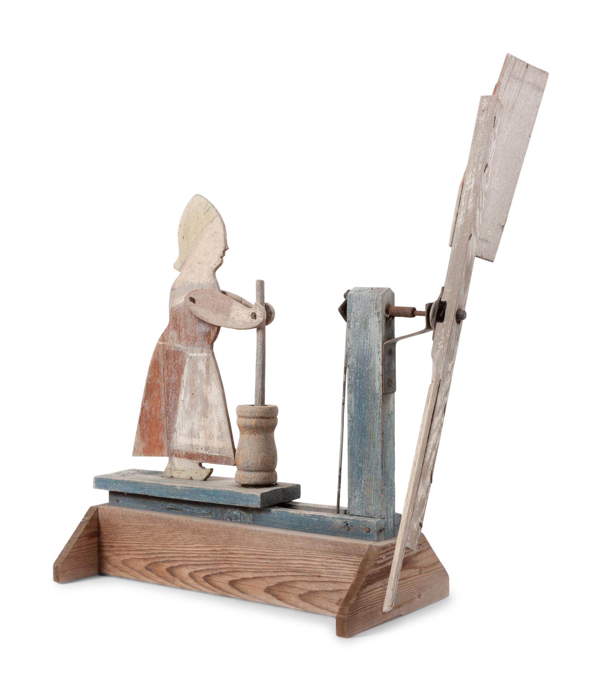 A Folk Art Carved and Painted Wood Butter Churn Whirligig