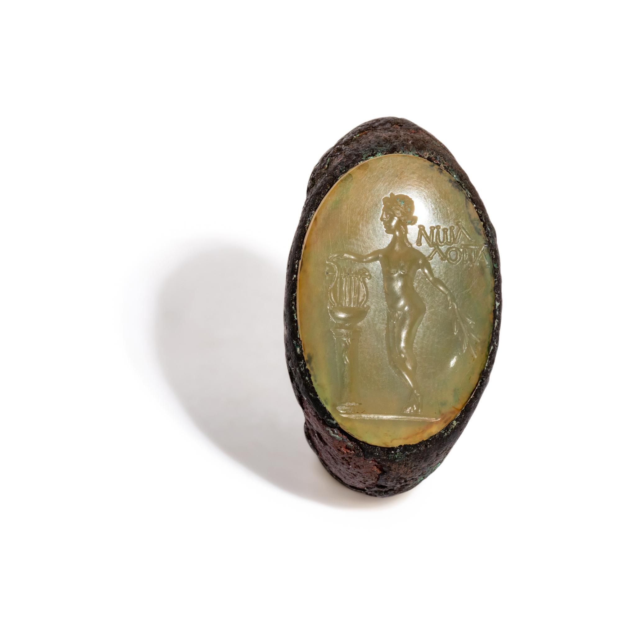 A Roman Copper Alloy and Chalcedony Finger Ring with the God Apollo