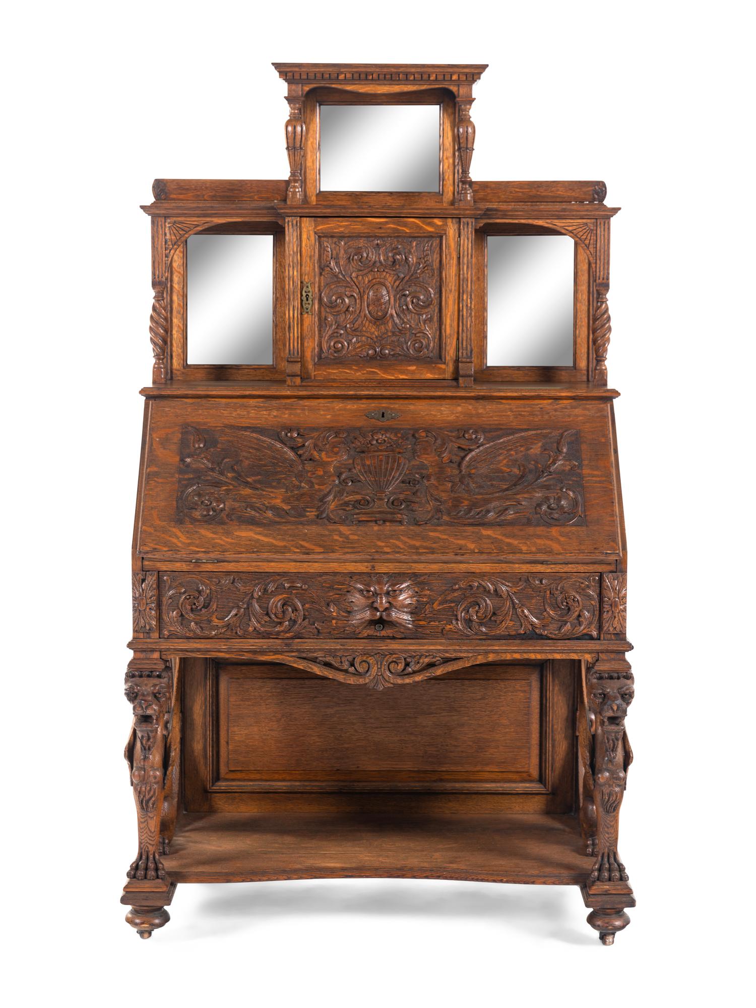 A Renaissance Revival Carved Oak Slant-Front Bureau
