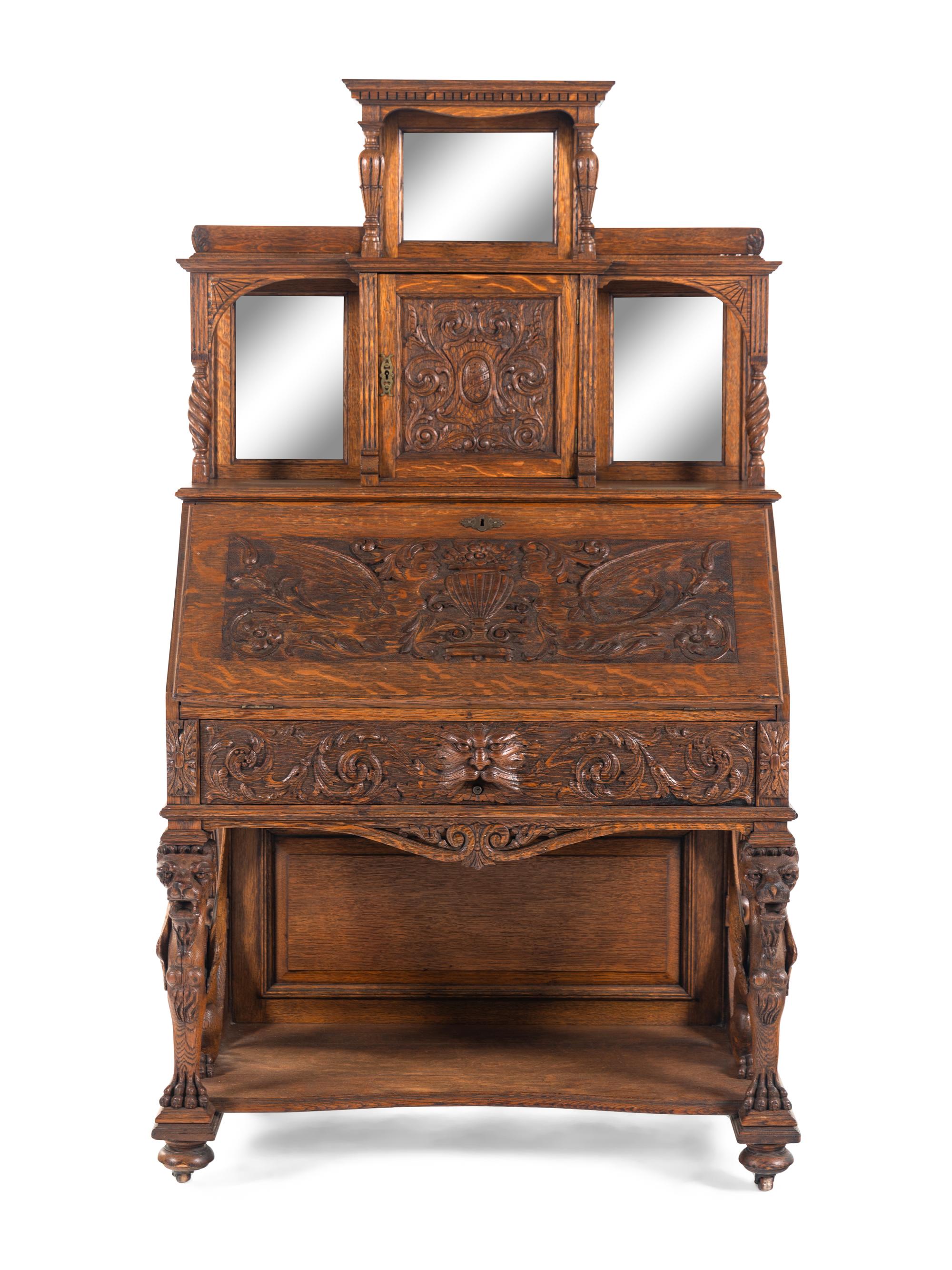 A Renaissance Revival Carved Oak Slant-Front Bureau