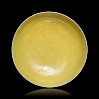 A Pair of Chinese Yellow Glazed Incised Porcelain 'Dragon' Dishes, Qianlong Marks and of the Period 清乾隆 嬌黃釉龍紋碟一對