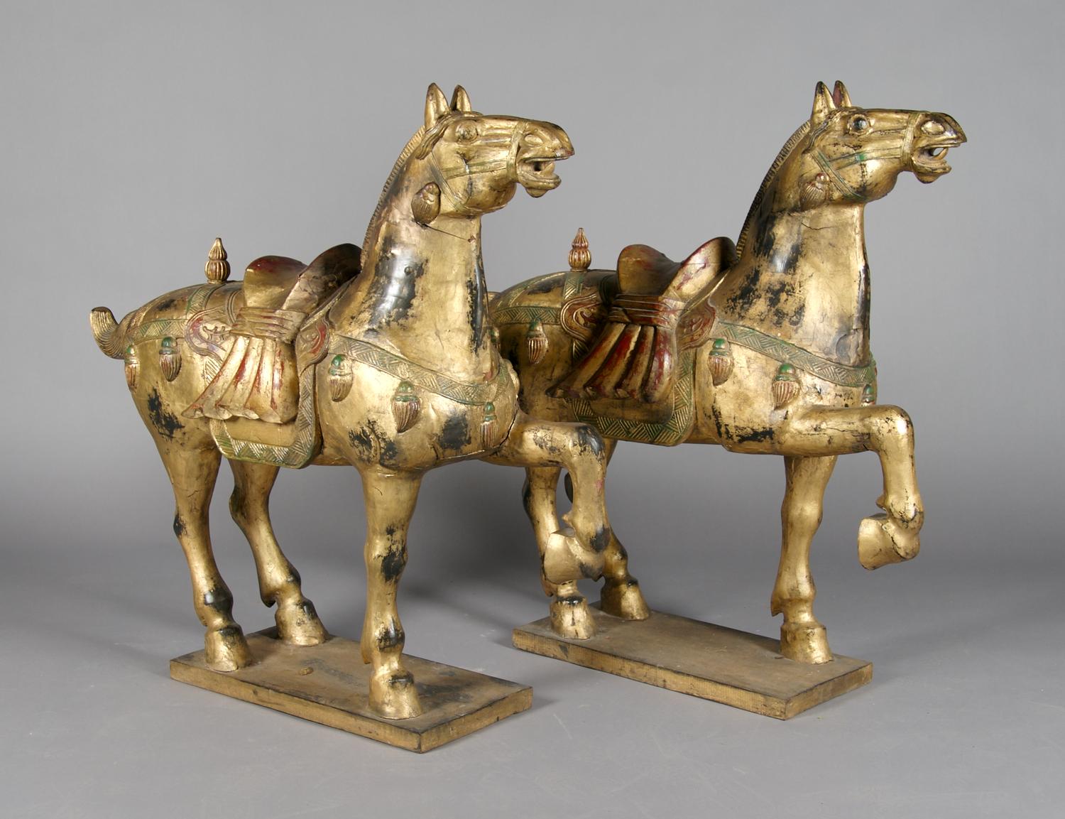 A Pair of Chinese Carved and Giltwood Horses, Height 42 inches.