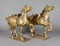 A Pair of Chinese Carved and Giltwood Horses, Height 42 inches.