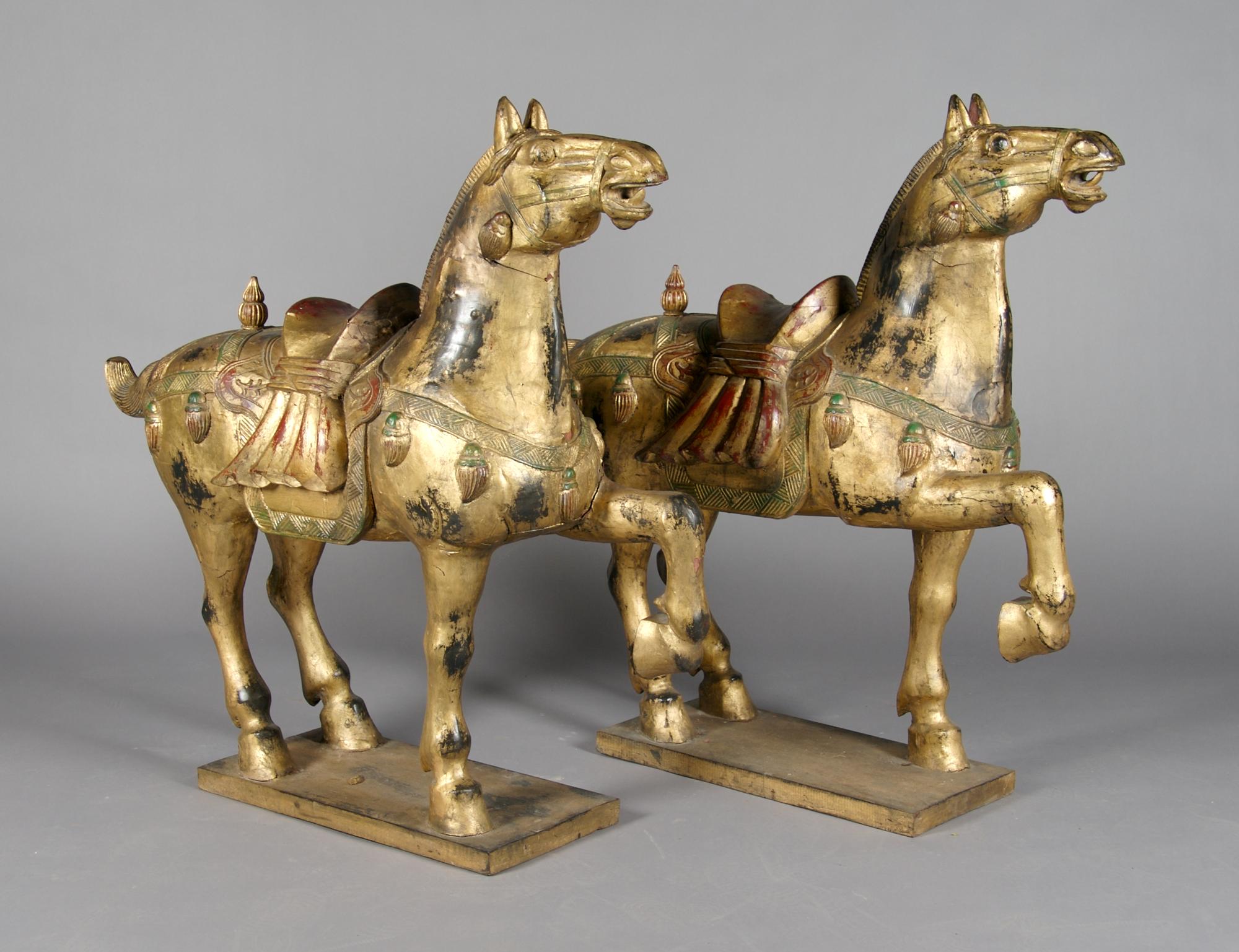 A Pair of Chinese Carved and Giltwood Horses, Height 42 inches.
