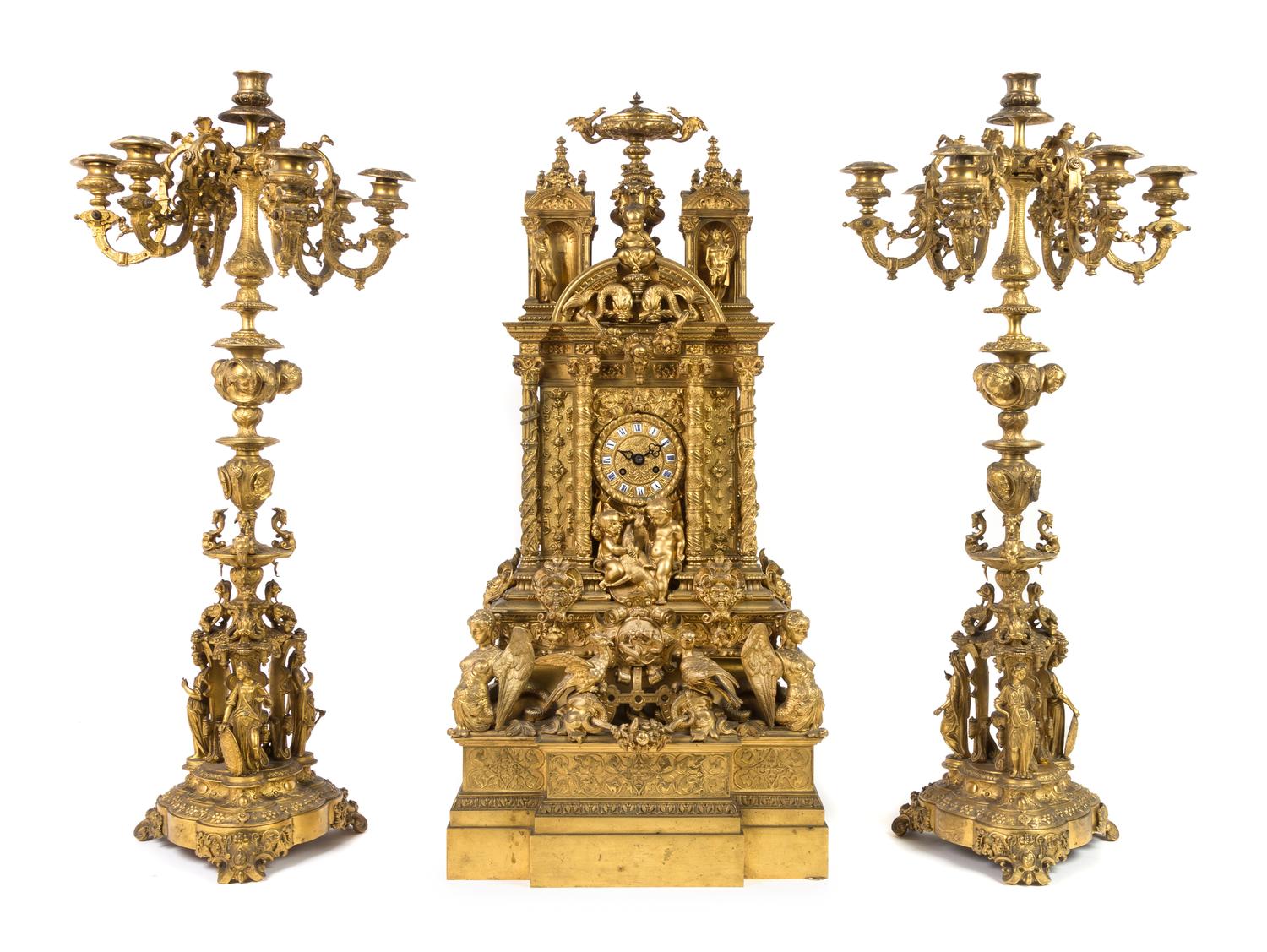 A French Gothic Revival Gilt Bronze Clock Garniture Height of mantel clock 31 3/4 inches. — 19TH CENTURY