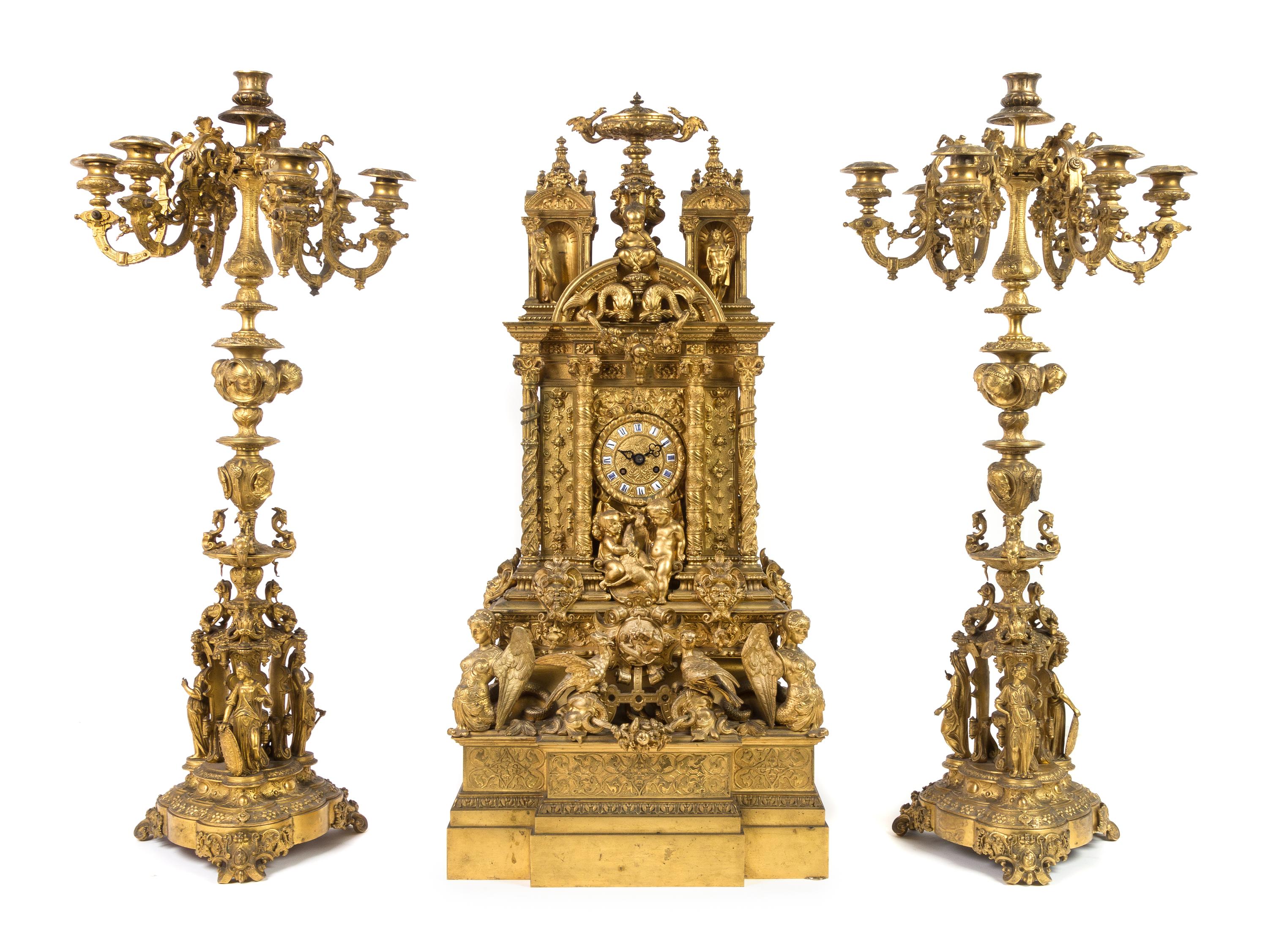A French Gothic Revival Gilt Bronze Clock Garniture Height of mantel clock 31 3/4 inches. — 19TH CENTURY