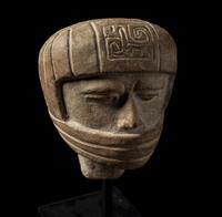 A Veracruz Terracotta Head Wearing a Helmet with an Incised Glyph