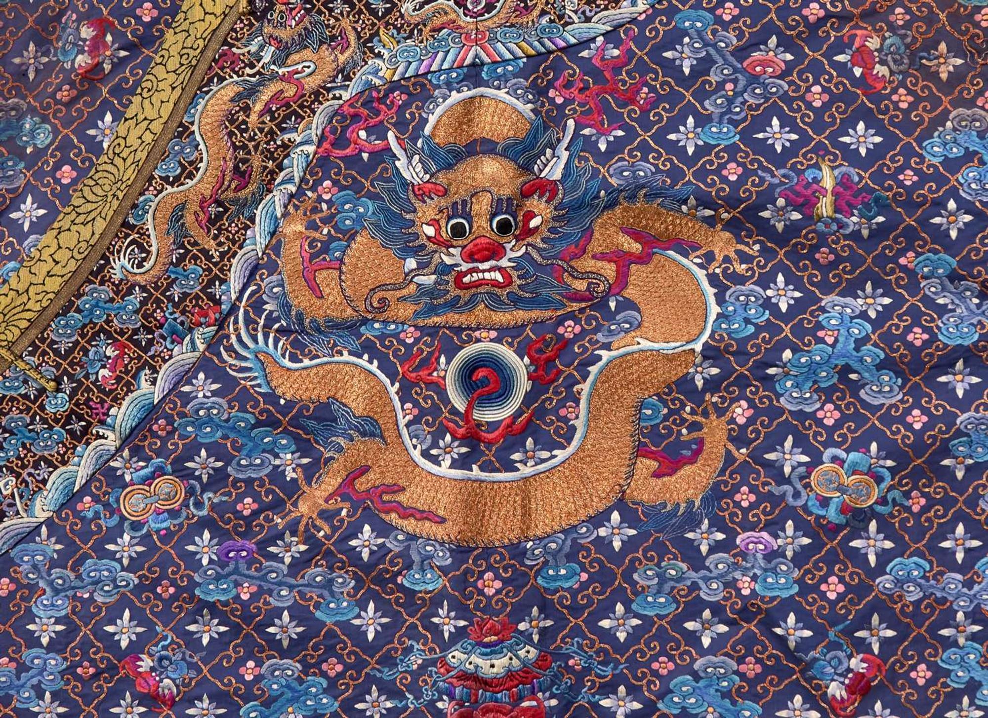 A Chinese embroidered blue silk "Nine-Dragon robe, Qing dynasty, circa 1900 海水江崖九龍紋袍 清 約1900年