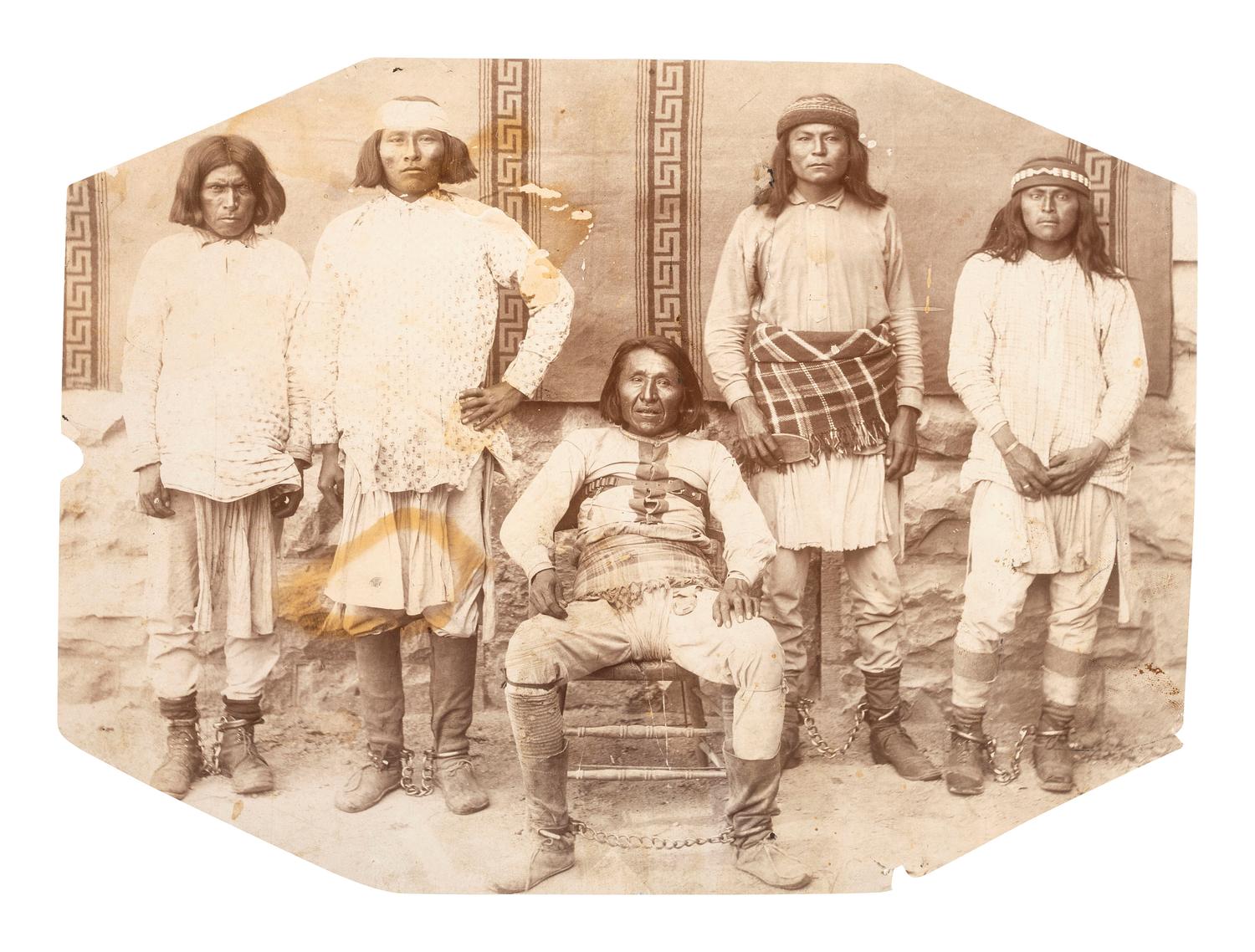 [NATIVE AMERICANS]. Unmounted large format photograph of captive Apache renegades in chains, incl. Pah-sla-gos-za, Kah-dos-la, Gon-Shay-ee, As-ki-say-la-ha, and Na-con-qui-say. [Florence, Arizona Territory]: ca 1880s.