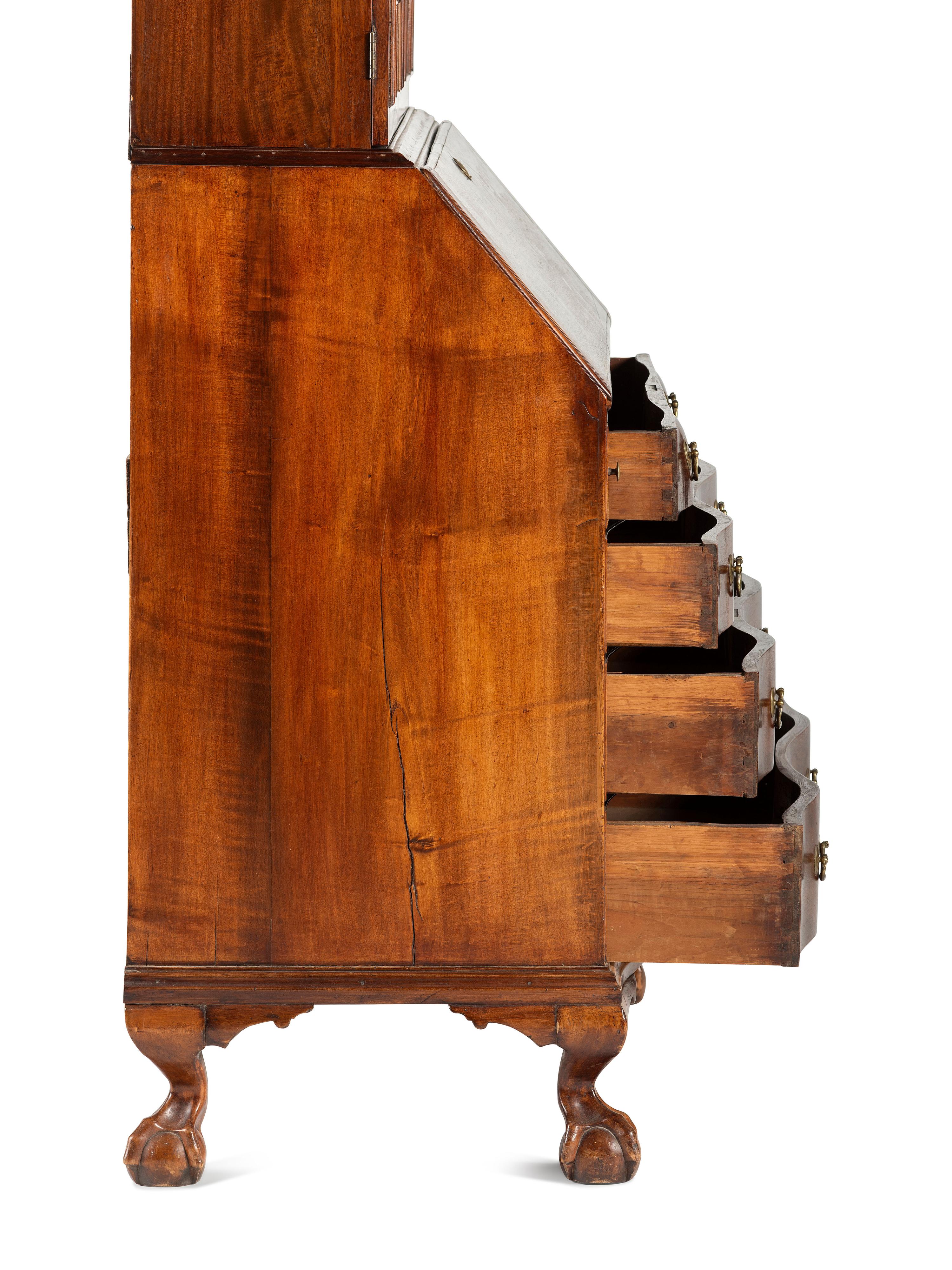 A Chippendale Mahogany and Cherrywood Serpentine Claw-and-Ball Foot Desk-and-Bookcase