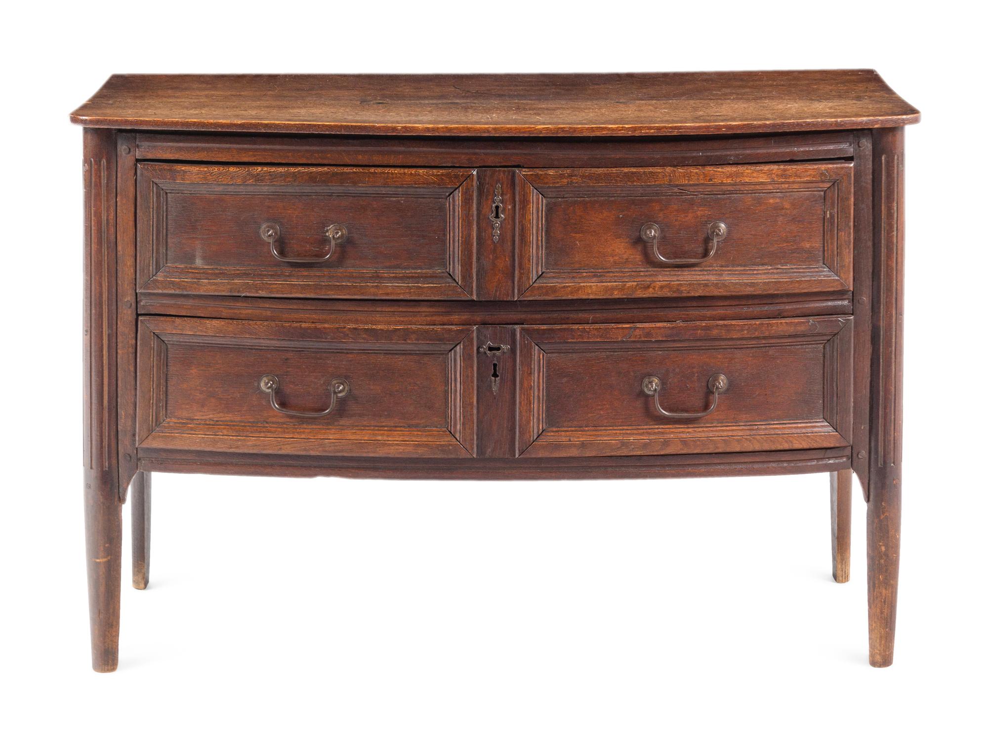 An Italian Oak Bow-Front Chest of Drawers