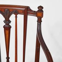 A group of three George III inlaid mahogany and satinwood dining chairs circa 1790