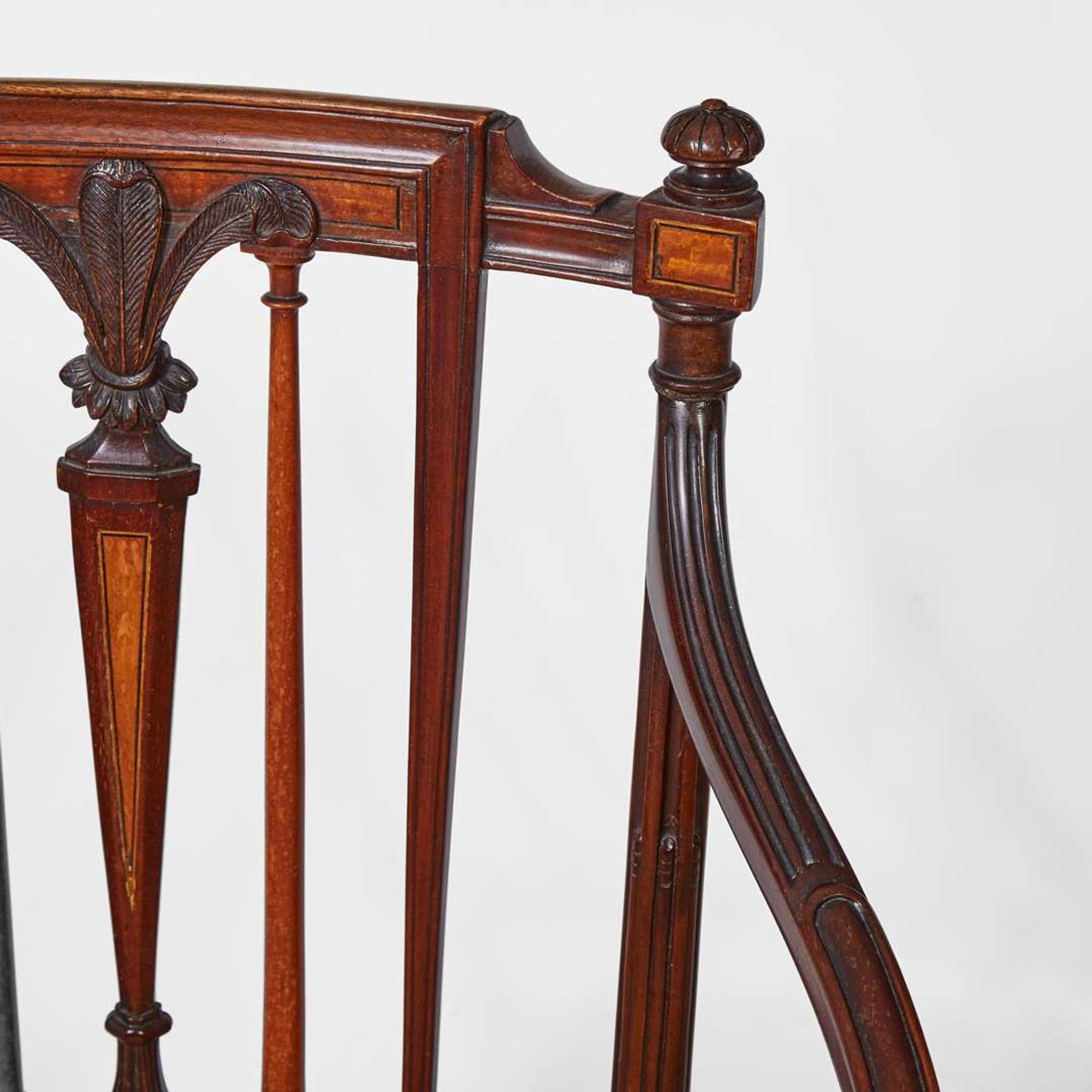 A group of three George III inlaid mahogany and satinwood dining chairs circa 1790