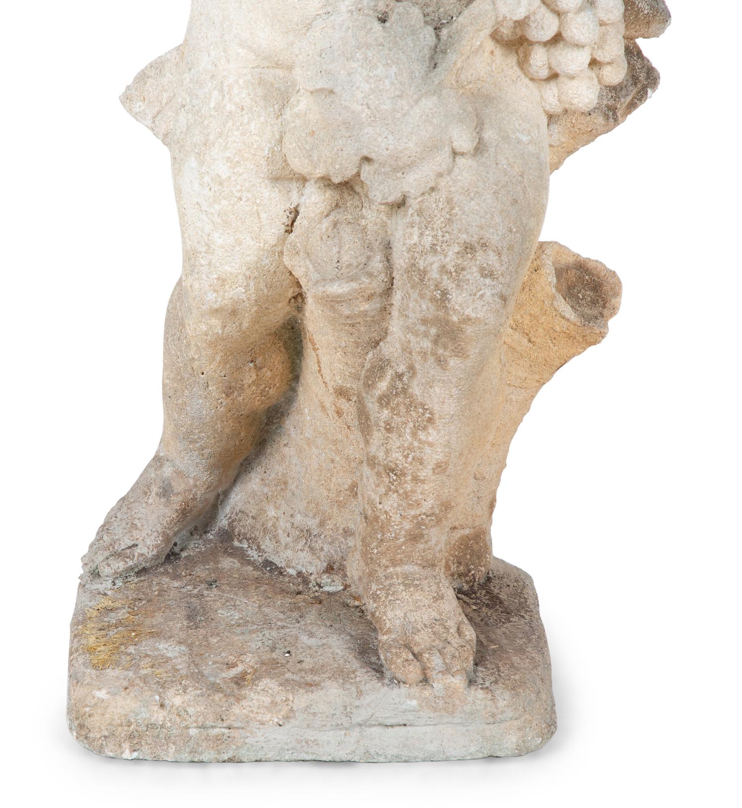 A Cast Stone Figure of Cherub Holding Grapes — 20TH CENTURY