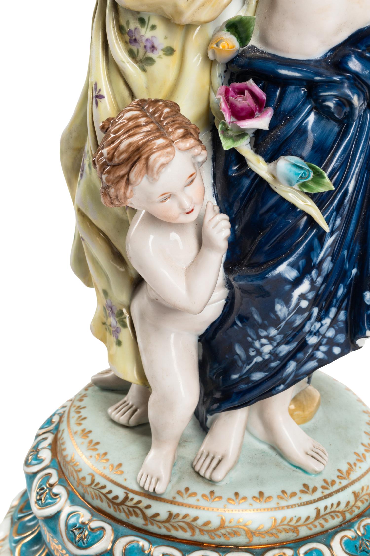 A Pair of Gilt Metal and Porcelain Figural Four-Light Candelabra