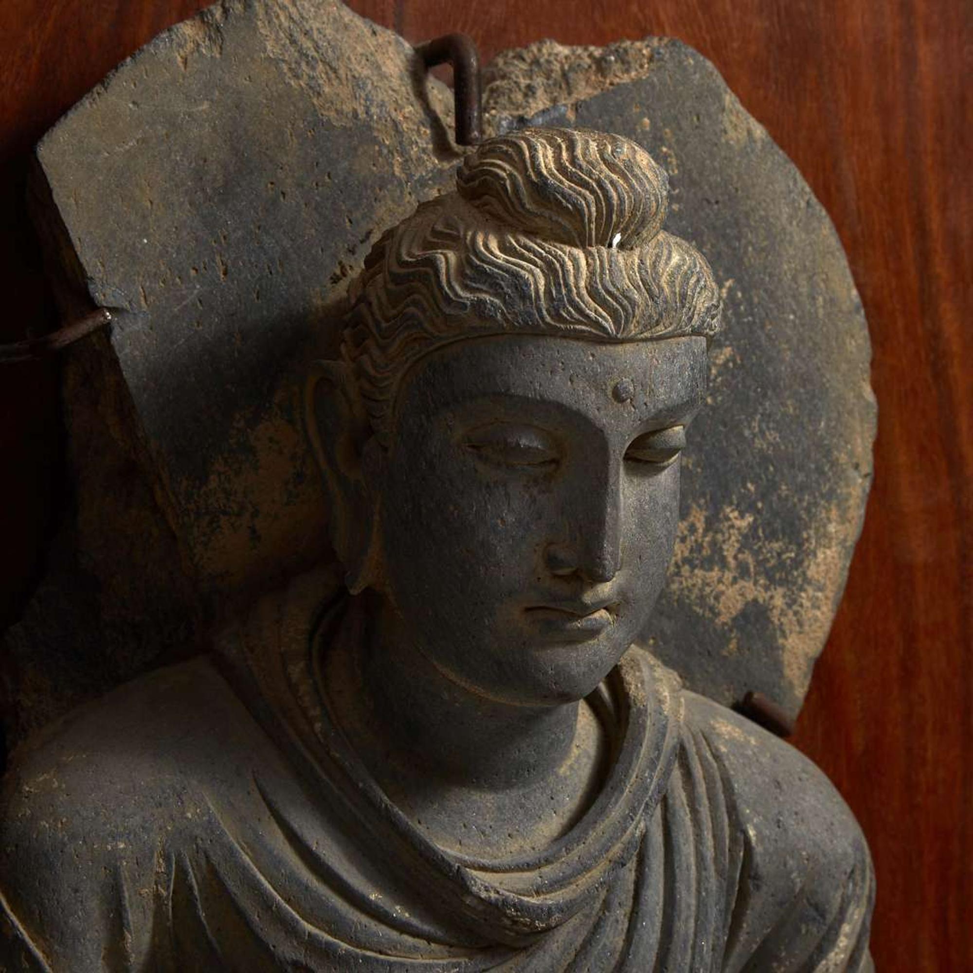 A carved schist figure of the seated Teaching Buddha, Ancient region of Gandhara, 2nd-3rd century 灰片岩雕像坐像 古犍陀羅地區，二至三世紀