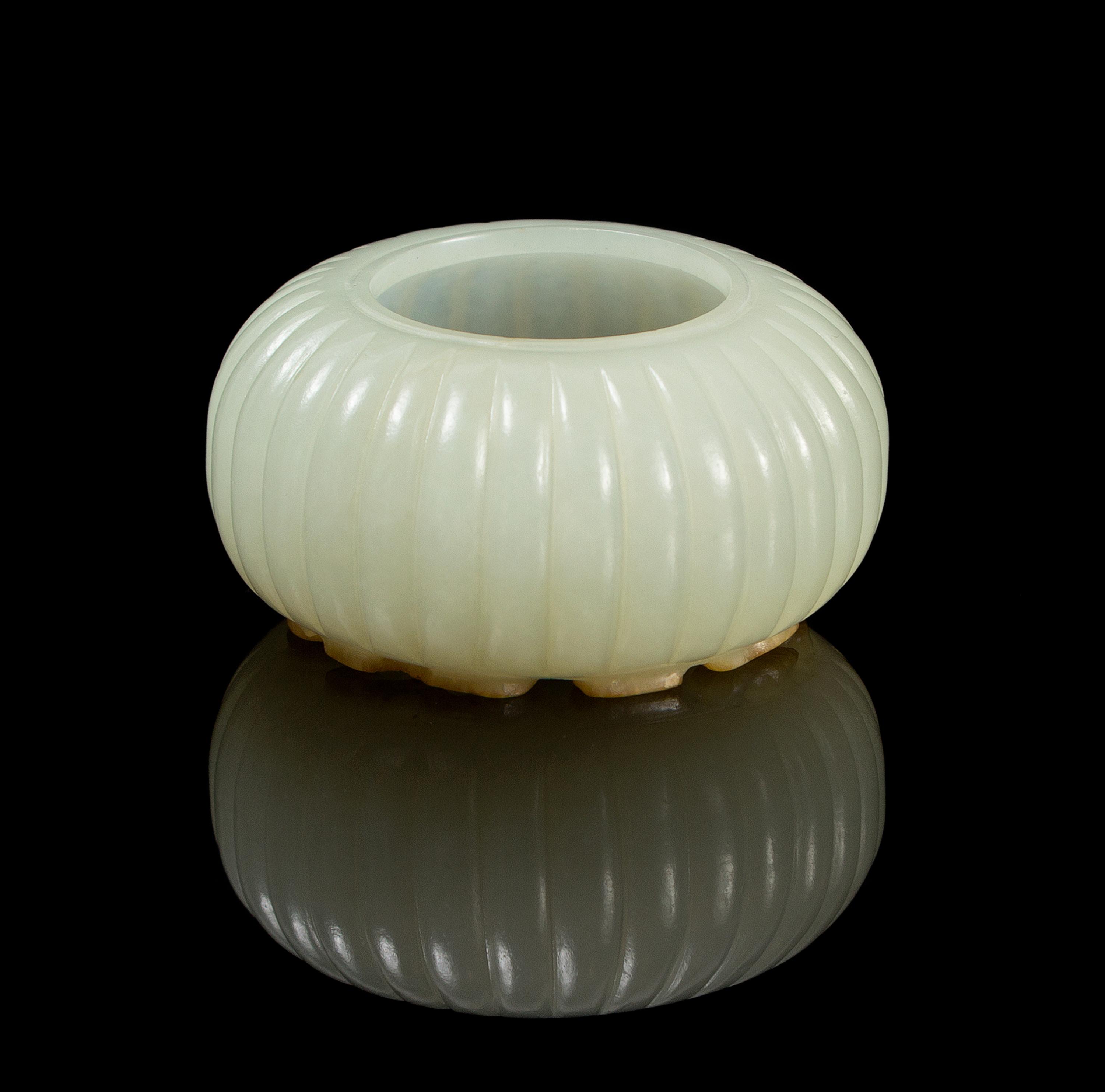 A Chinese Light Celadon Jade Fluted Water Pot 18TH/19TH CENTURY Diameter overall 2 1/8 inches. — 18TH/19TH CENTURY