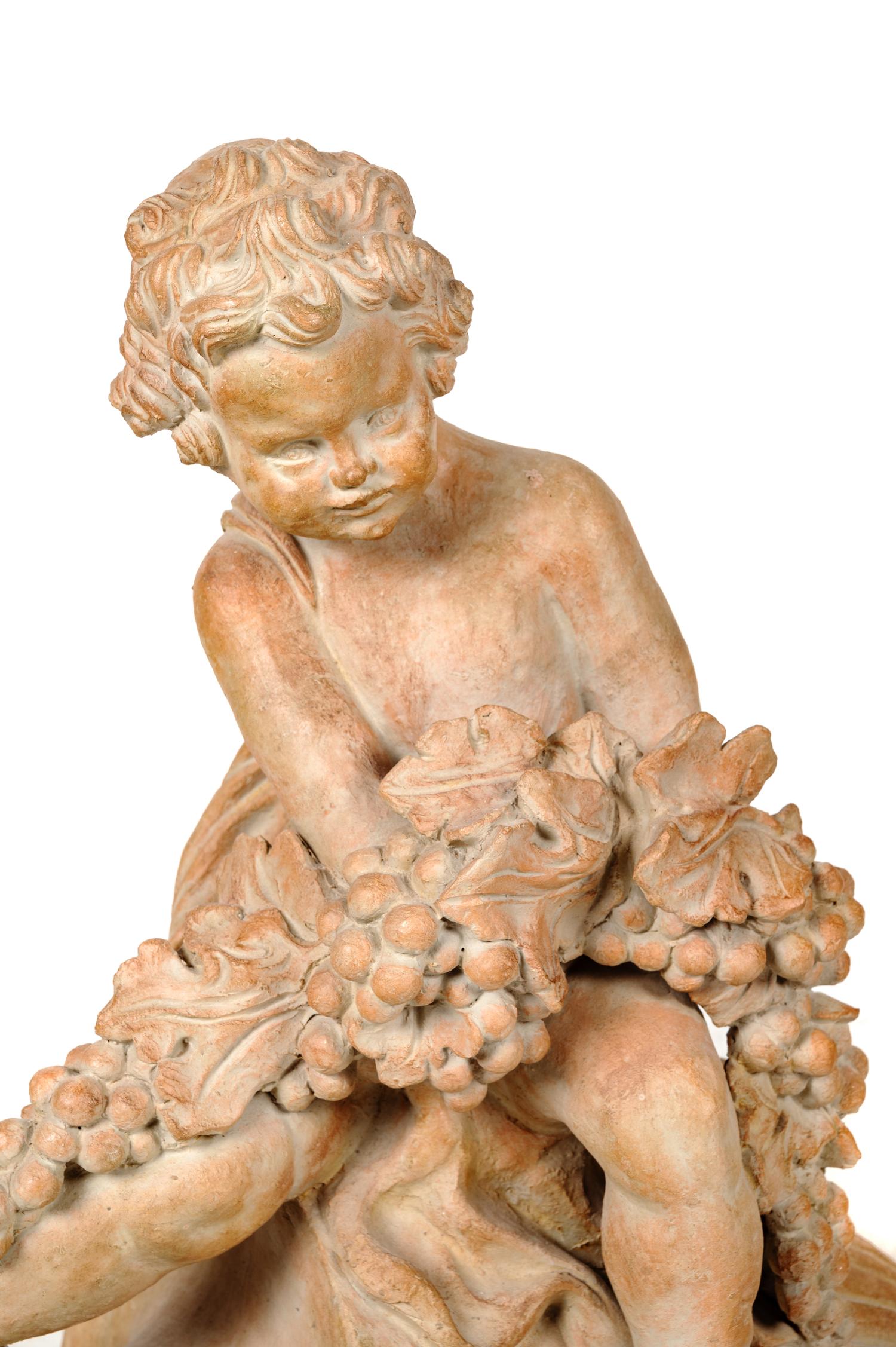 A Pair of Terra Cotta Putti Ornaments