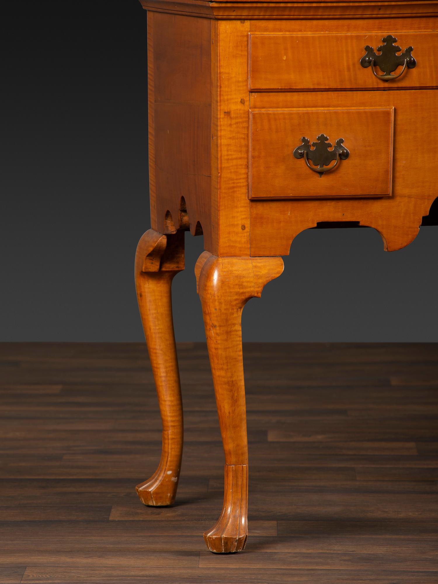 A Queen Anne Fan-Carved Tiger Maple Bonnet-Top Tablet-Foot High Chest