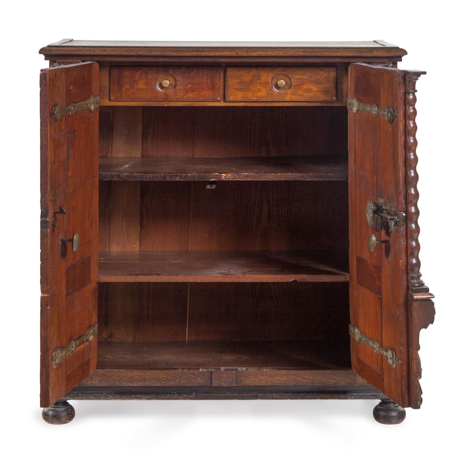 An Italian Baroque Carved Walnut and Oak Cabinet
