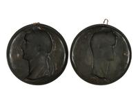 A Pair of Continental Patinated and Parcel Gilt Bronze Plaques of Roman Emperors
