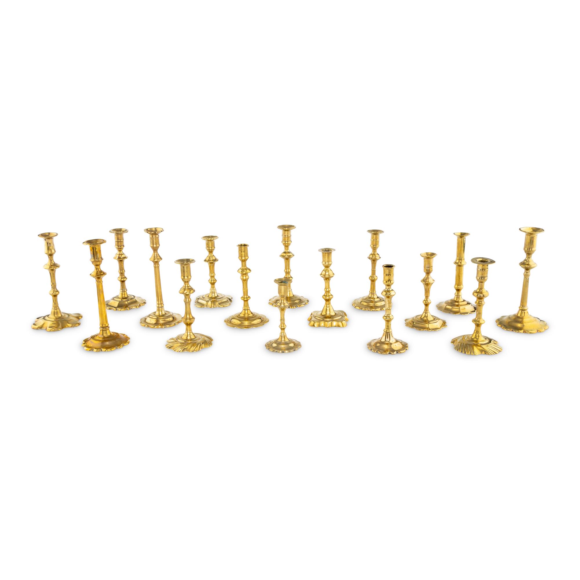 A Group of Sixteen Brass Candlesticks
