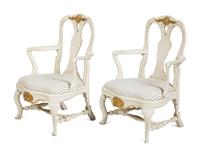 A Pair of Swedish White-Painted and Parcel-Gilt Open Armchairs