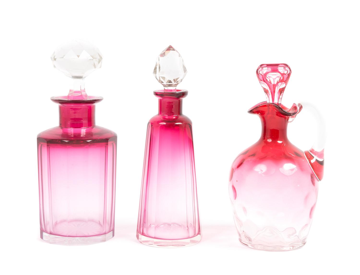 Three Cranberry Glass Cruets Height of tallest 7 inches.