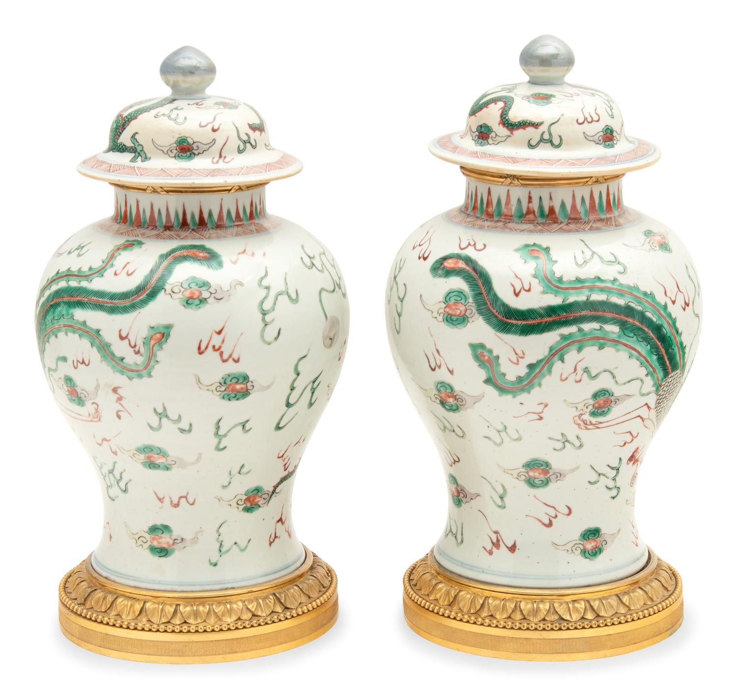 A Pair of Gilt Bronze Mounted Wucai Porcelain Baluster Jars and Covers