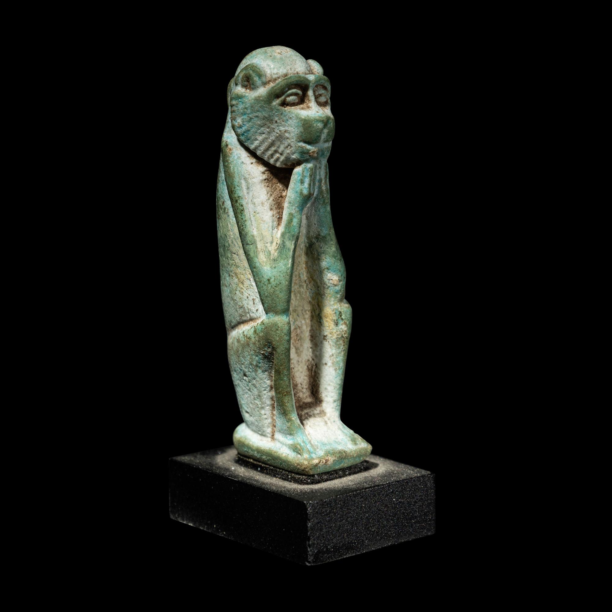 An Egyptian Faience Seated Monkey