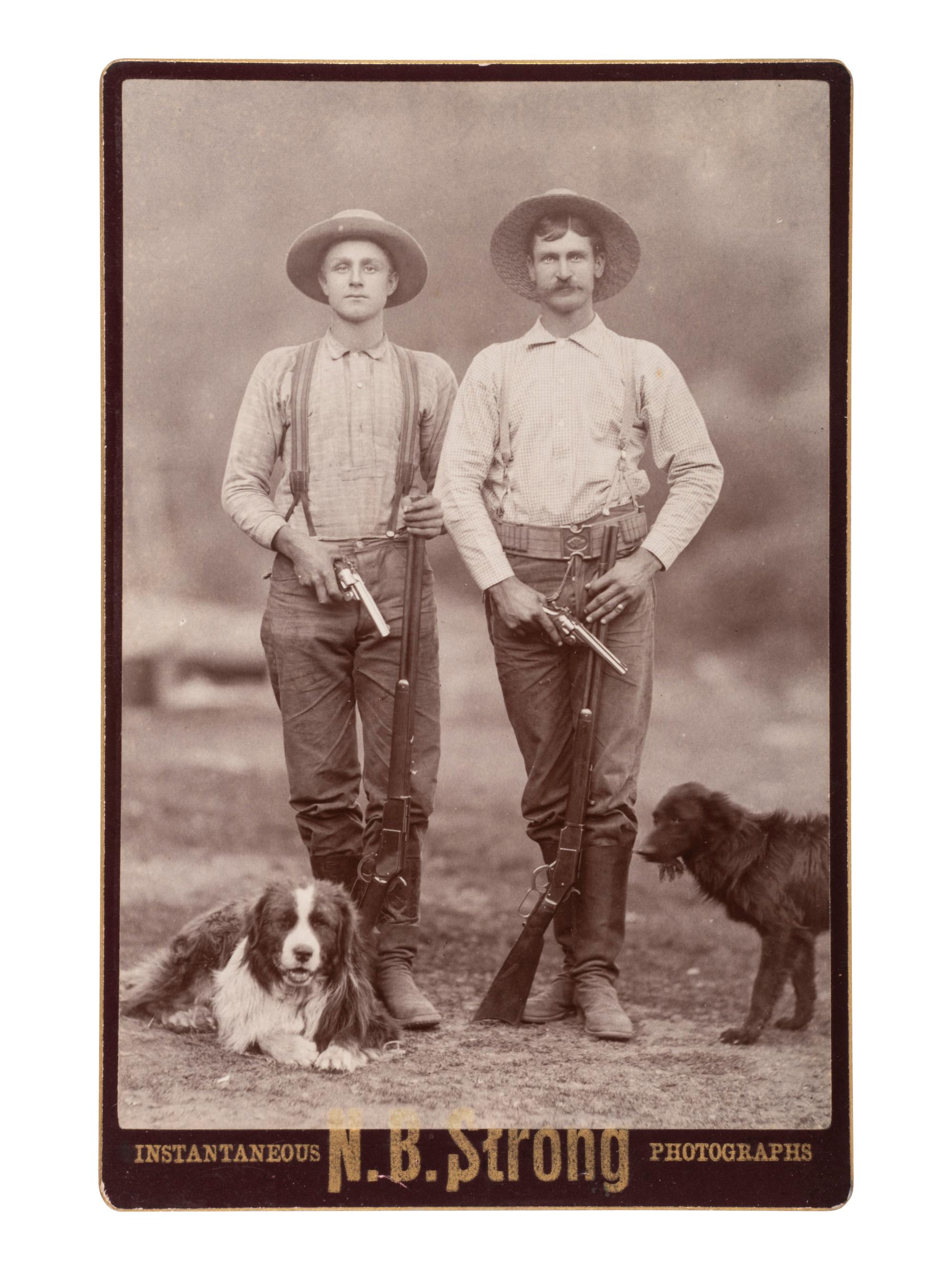 [EARLY PHOTO] Cabinet card of doubly-armed men with their dogs. [Eureka, CA]: N.B. Strong, ca 1880s.