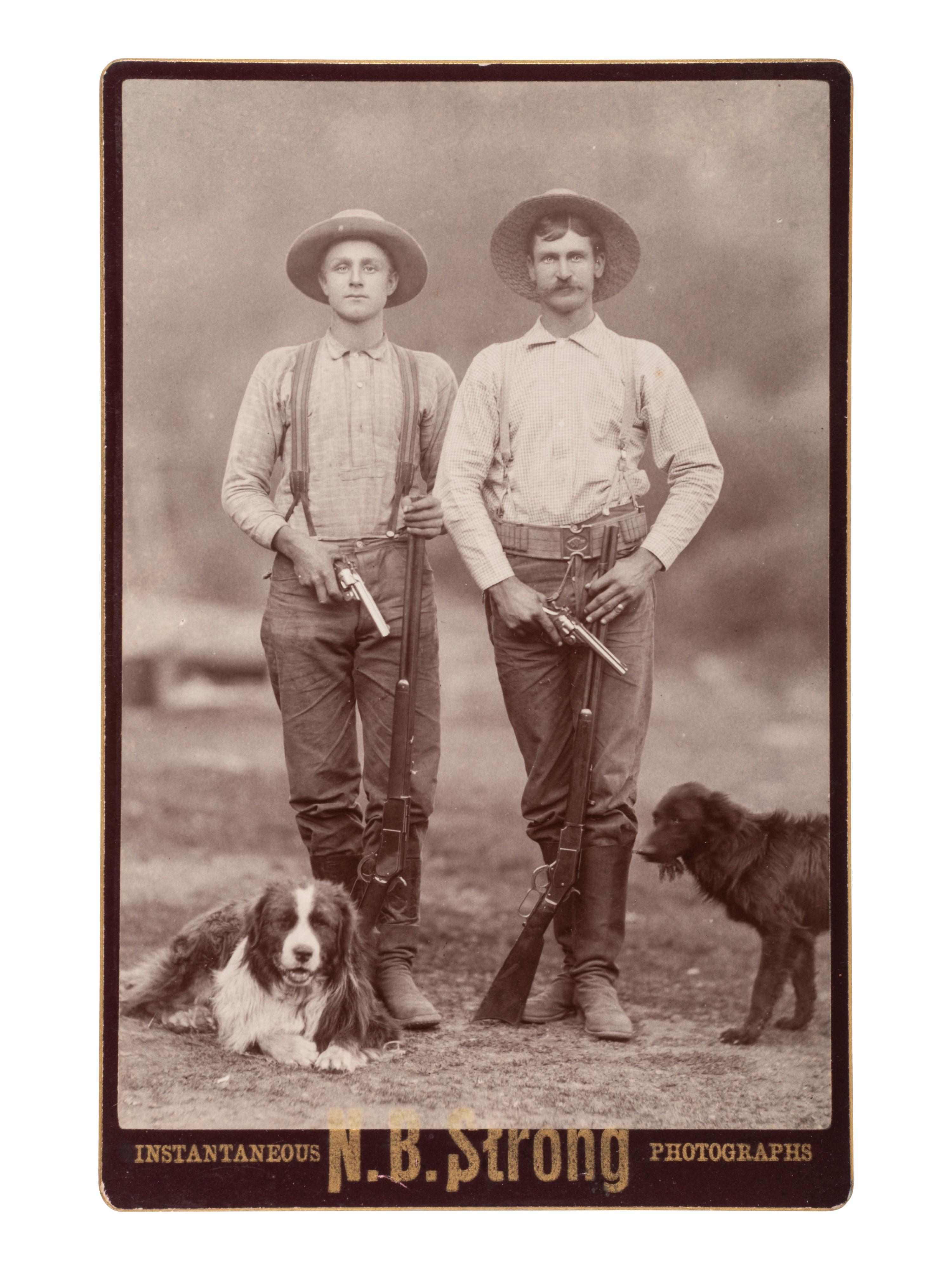 [EARLY PHOTO] Cabinet card of doubly-armed men with their dogs. [Eureka, CA]: N.B. Strong, ca 1880s.
