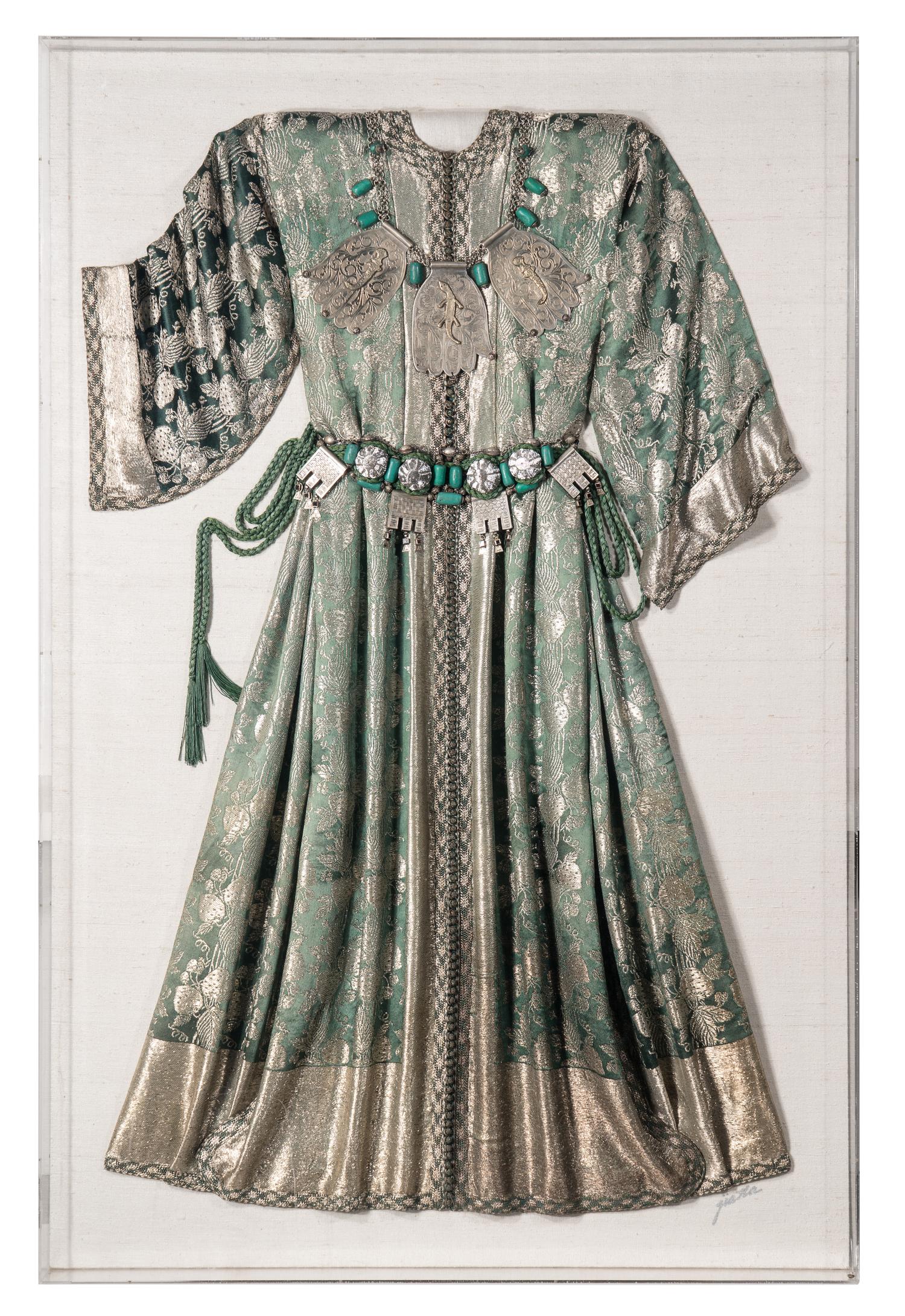 A Middle Eastern Metal and Stone-Embellished Dress in an Acrylic Frame