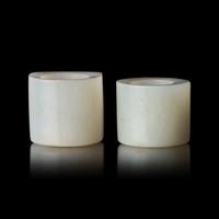 Two Chinese Russet and White Jade Archer's Rings, 18th/19th Century 清中期 白玉灑金皮扳指兩枚