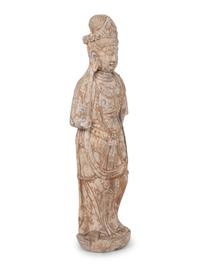A Chinese Carved Stone Standing Guanyin Figure with Remnants of Polychrome Decoration