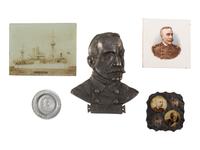 [SPANISH-AMERICAN WAR]. A group of milk glass, paperweights, glasses, and other souvenirs including items commemorating the Maine and Admiral Dewey, including: