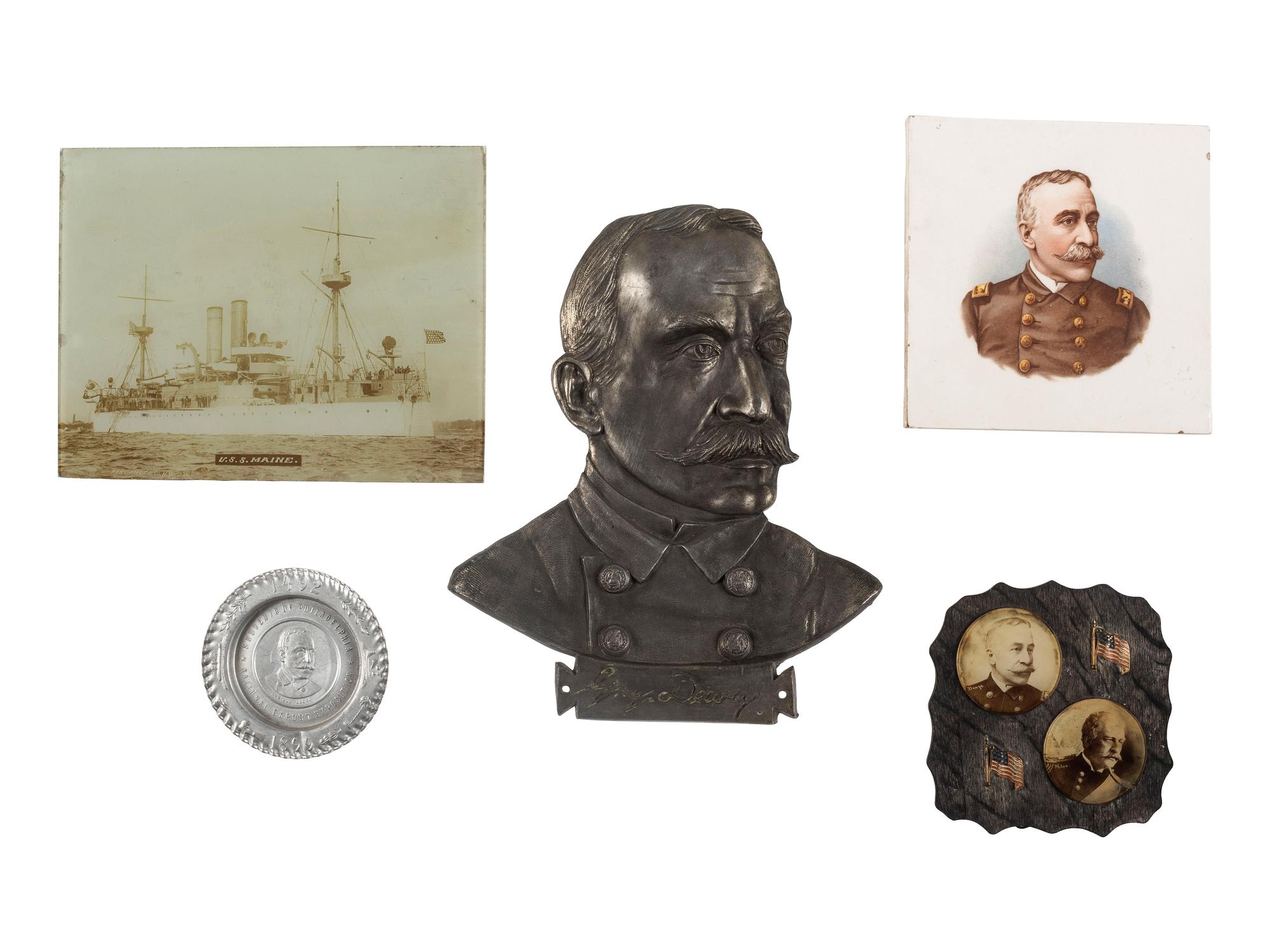 [SPANISH-AMERICAN WAR]. A group of milk glass, paperweights, glasses, and other souvenirs including items commemorating the Maine and Admiral Dewey, including:
