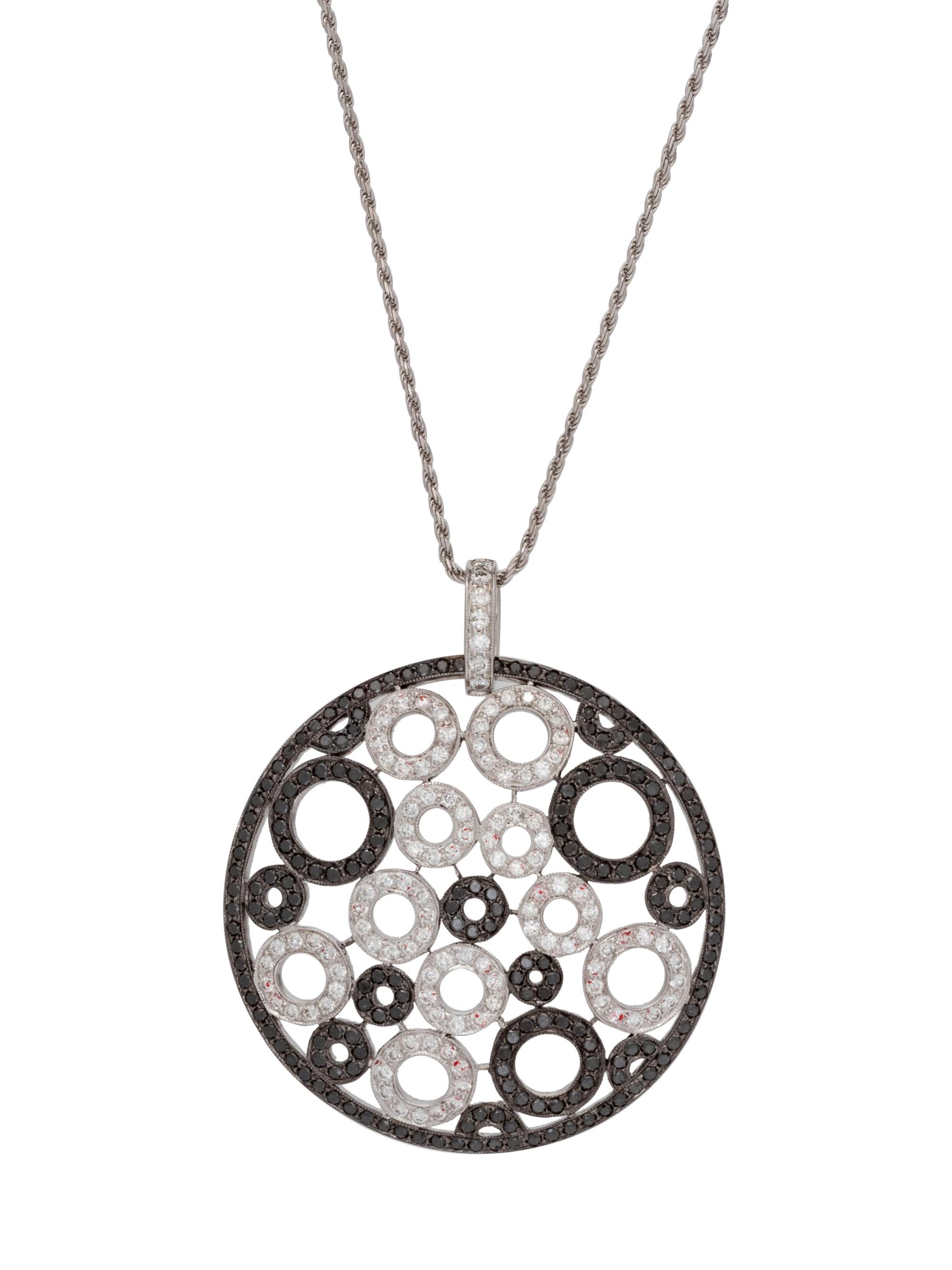 An 18 Karat White Gold, Black Diamond and Diamond Pendant/Necklace,