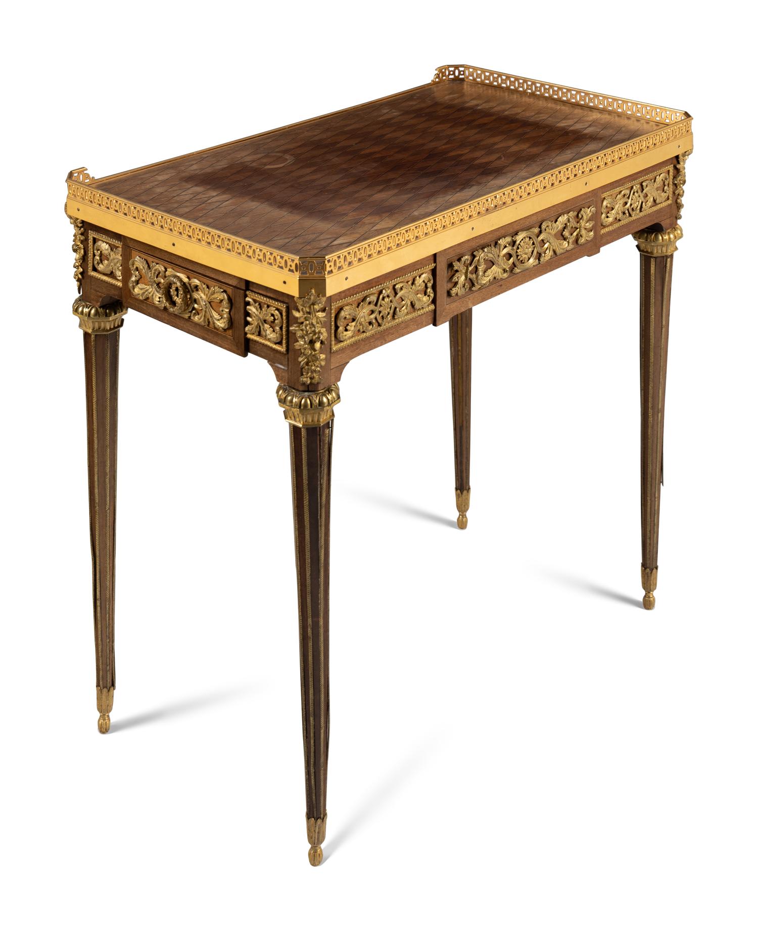 A Louis XVI Style Gilt Bronze Mounted Mahogany and Parquetry Table