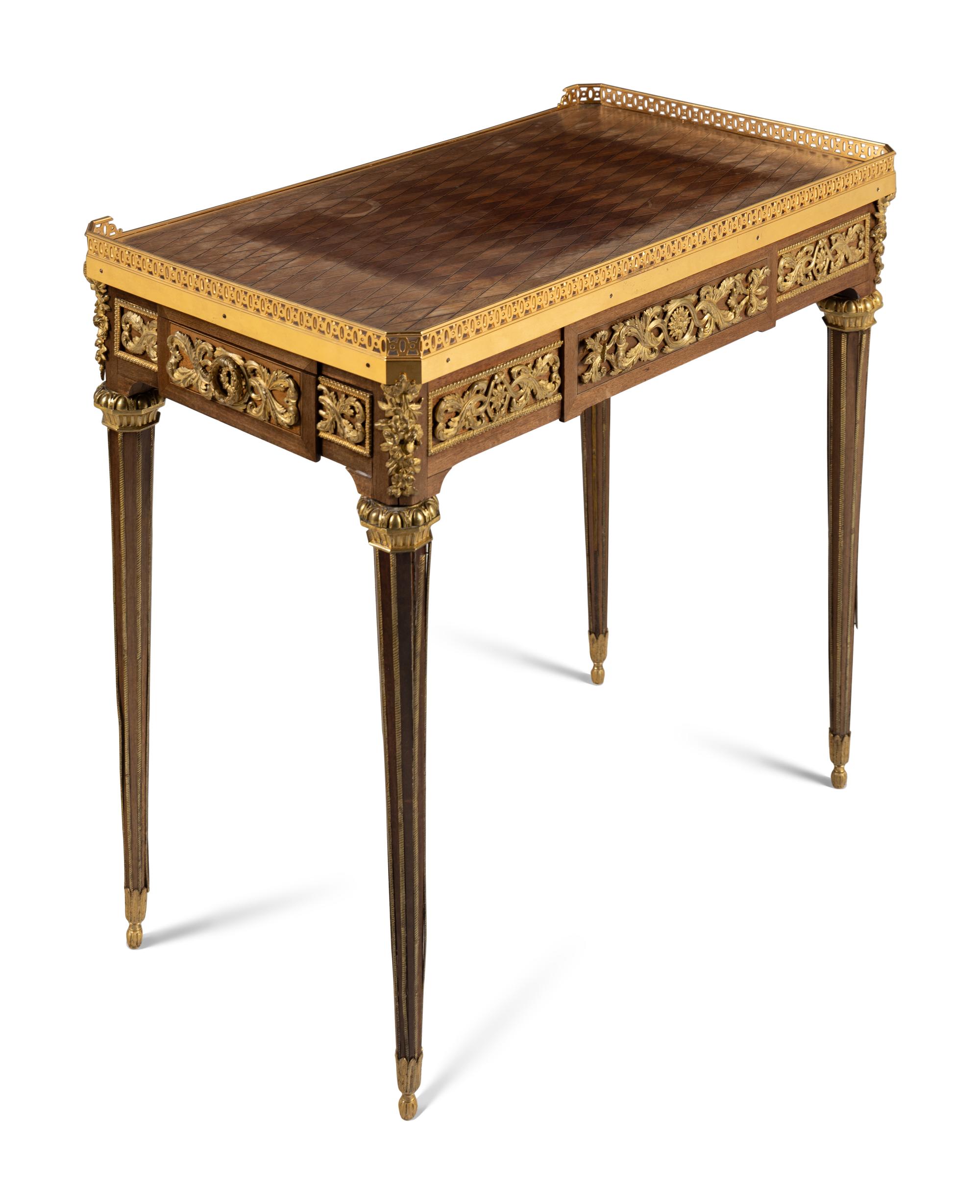 A Louis XVI Style Gilt Bronze Mounted Mahogany and Parquetry Table