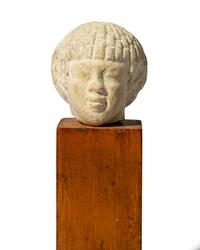 An Egyptian Limestone Head of a Nubian