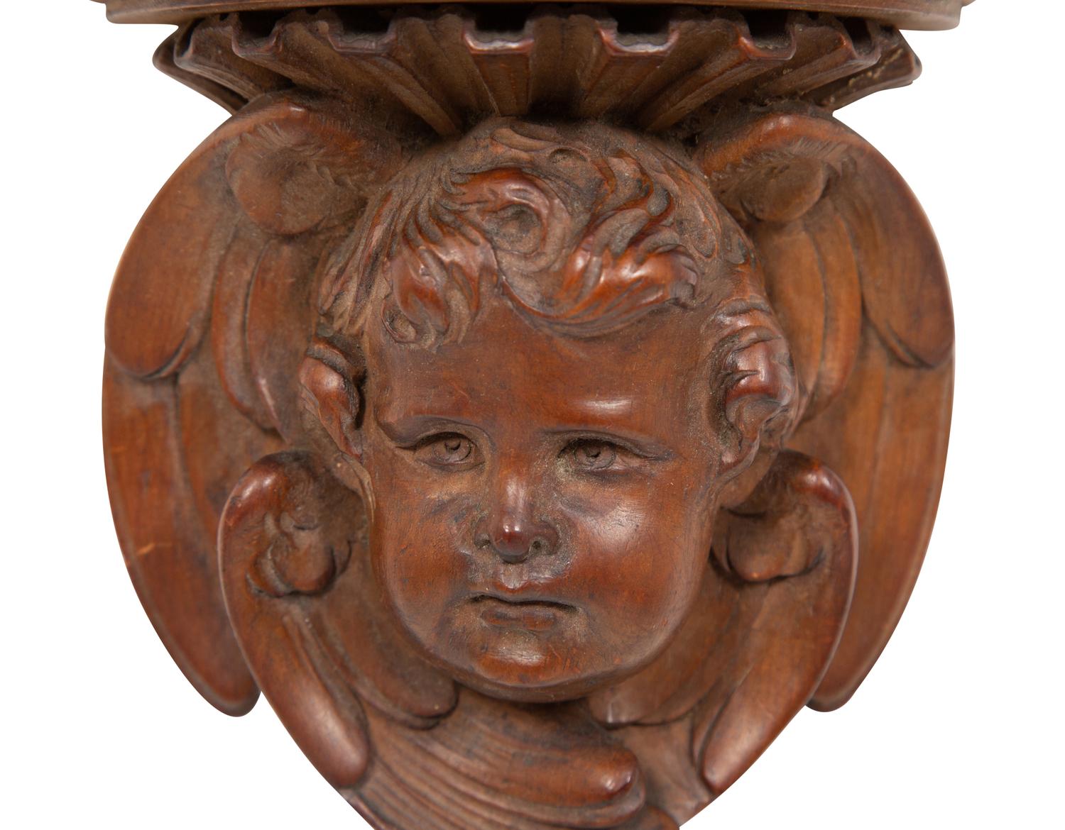 A Pair of English Carved Pear Wood Cherub Wall Brackets