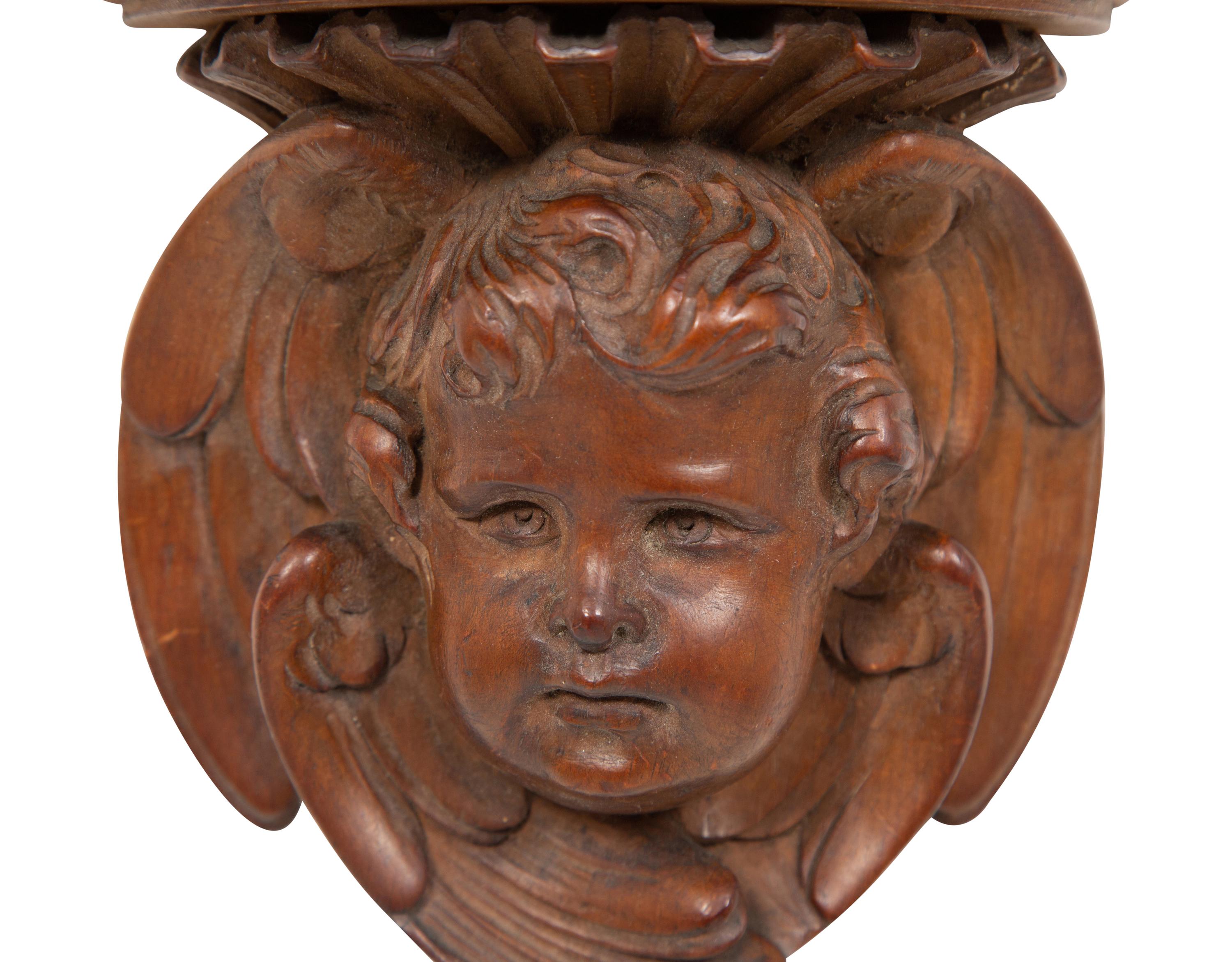 A Pair of English Carved Pear Wood Cherub Wall Brackets