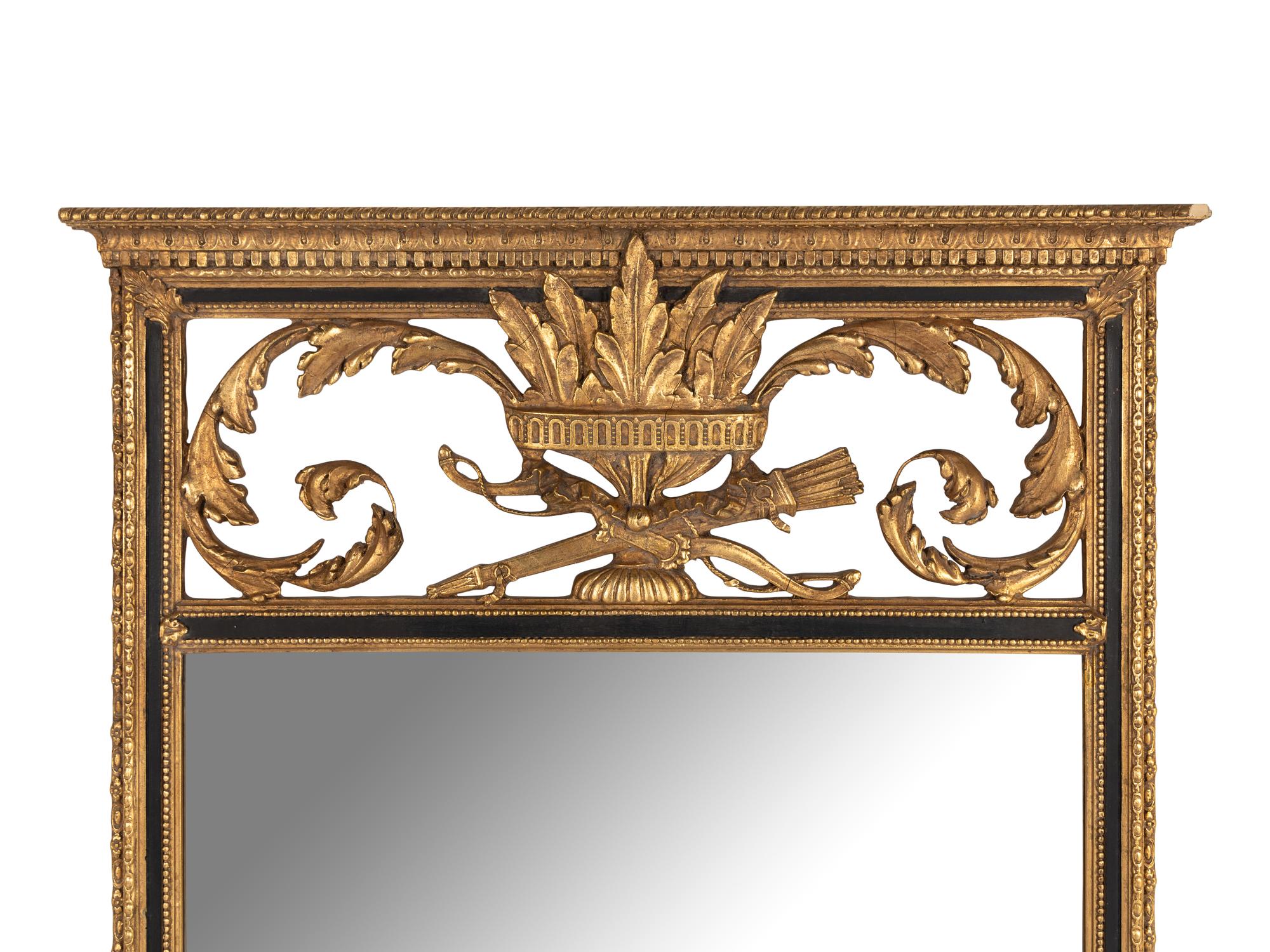 An Empire Style Parcel Ebonized Giltwood Mirror
